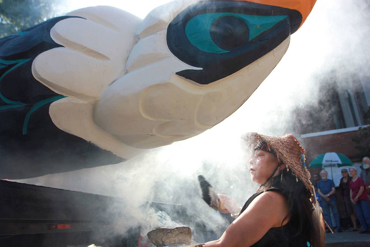 Linda Soriano of the Lummi Nation performs a smudge ceremony at Saint Mark’s Episcopal Cathedral in Seattle last Thursday, fanning smoke from burning sage with eagle feathers onto a totem pole. The 22-foot-tall Lummi Nation totem pole is traveling nearly 5,000 miles across the U.S. and Canada to galvanize opposition to the development of fossil fuel infrastructure, particularly around sea ports in Oregon and Washington. (Manuel Valdes/The Associated Press)