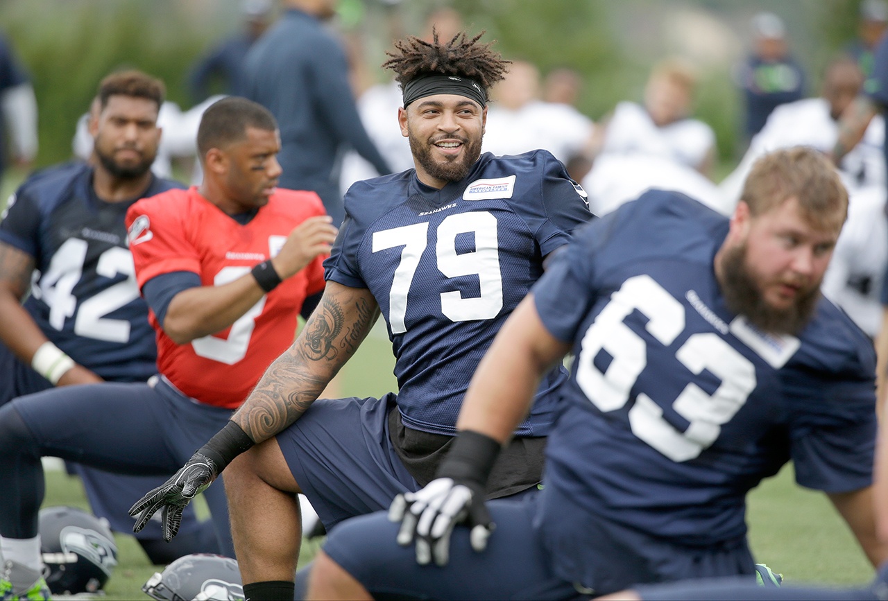 Seattle Seahawks’ Garry Gilliam stretches during the team’s NFL football training camp Saturday, July 30, 2016, in Renton, Wash. (AP Photo/Elaine Thompson)