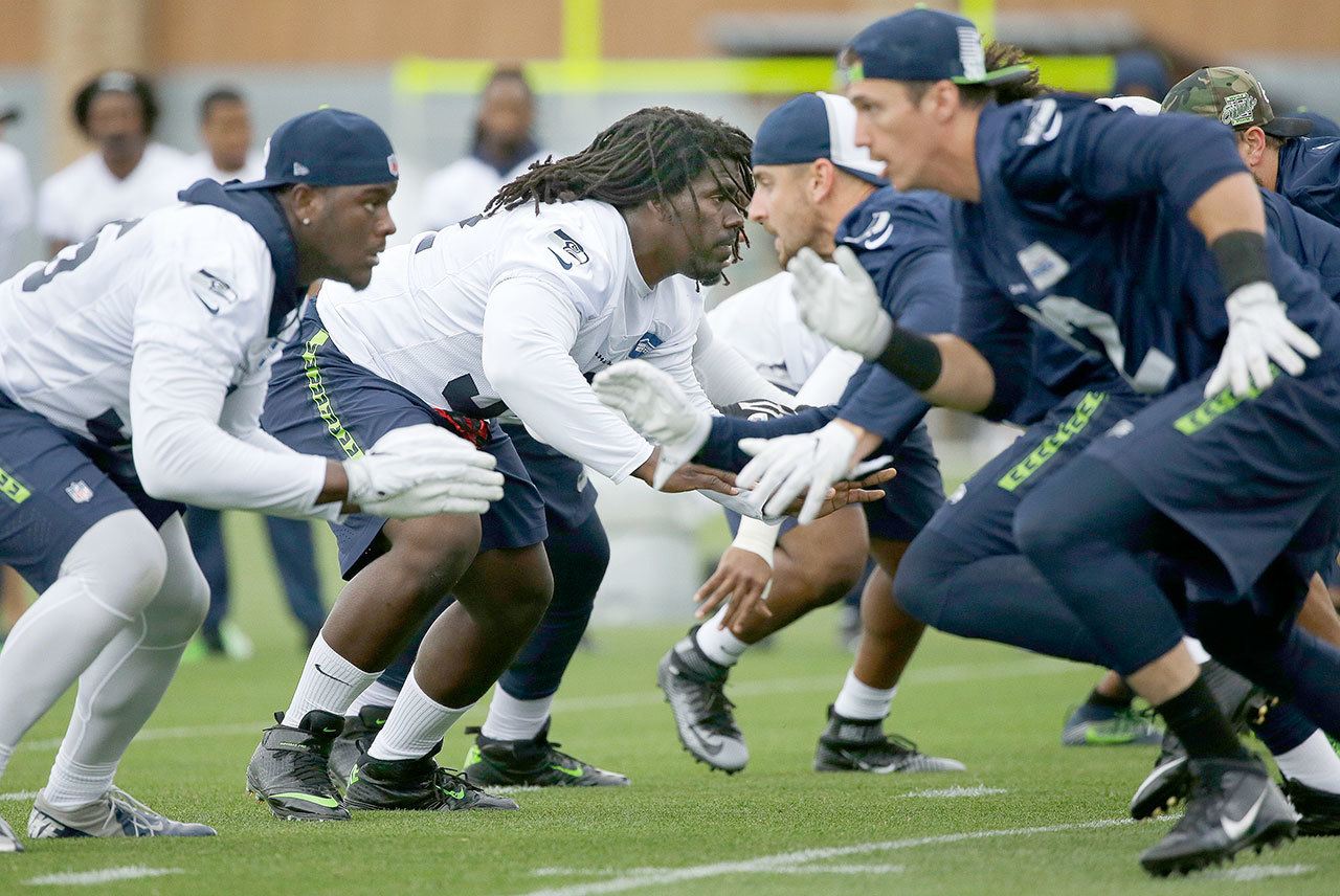 The Associated Press                                Seattle Seahawks defensive tackle Brandin Bryant, second from left, prepares to rush the passer during a recent practice.