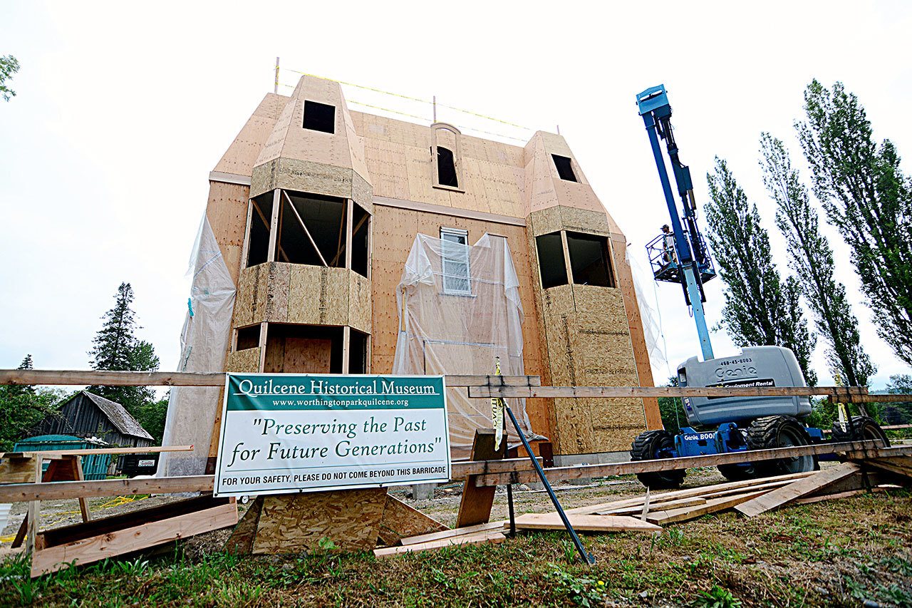 Crews worked Wednesday on adding the roof to the Worthington Mansion at Worthington Park in Quilcene. When finished, the roof should look identical to the mansion’s first roof. (Jesse Major/Peninsula Daily News)