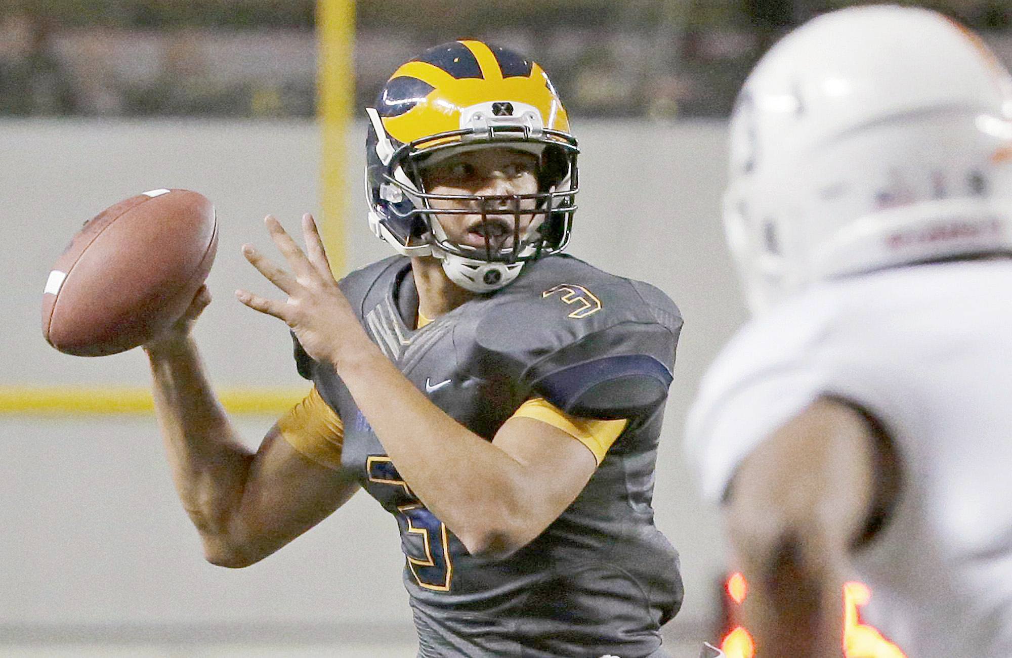 The Associated Press Bellevue quarterback Justus Rogers looks to pass during the Class 3A state football championship last December. Rogers has switched positions and is now playing defense for Washington State.
