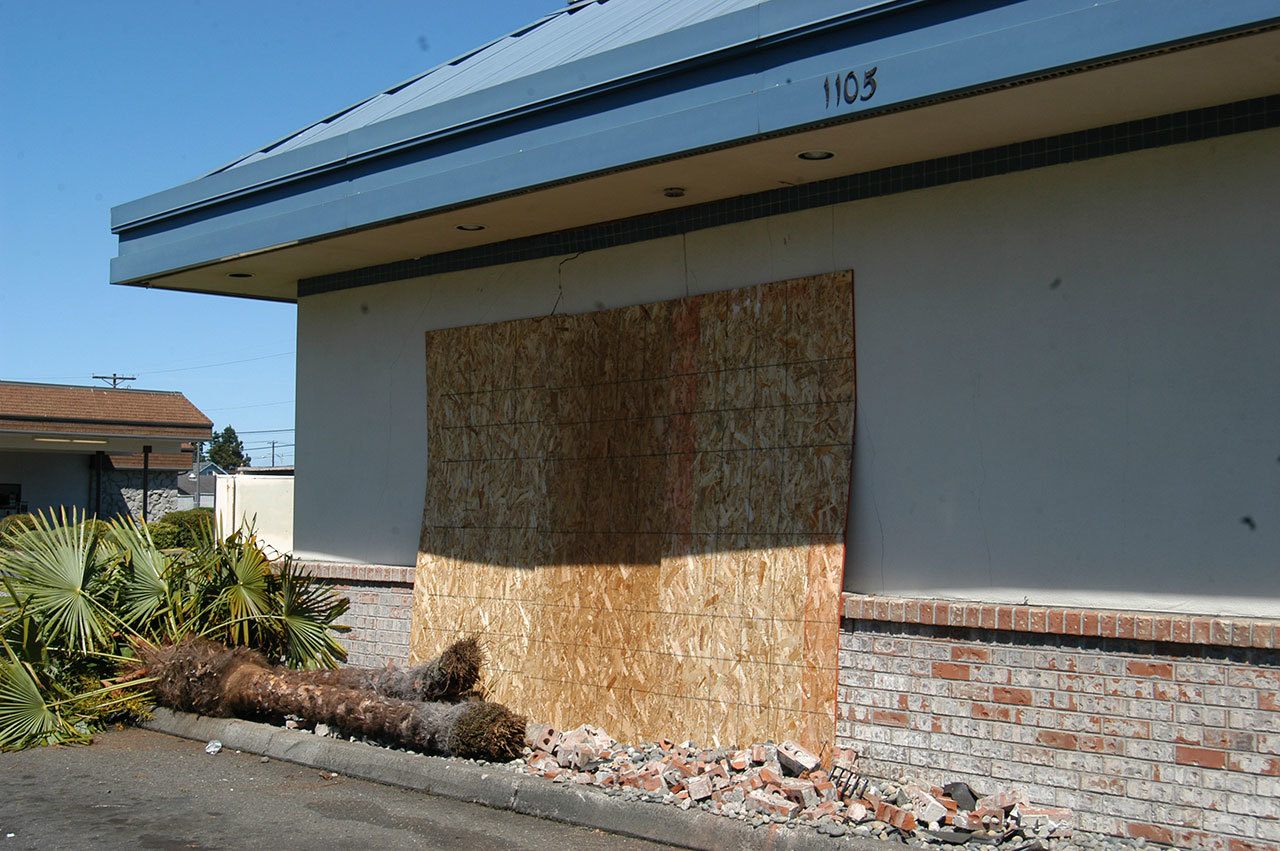 Damage is boarded up at the Port Angeles Taco Time after a vehicle crashed into the building early Sunday. (Rob Ollikainen/Peninsula Daily News)