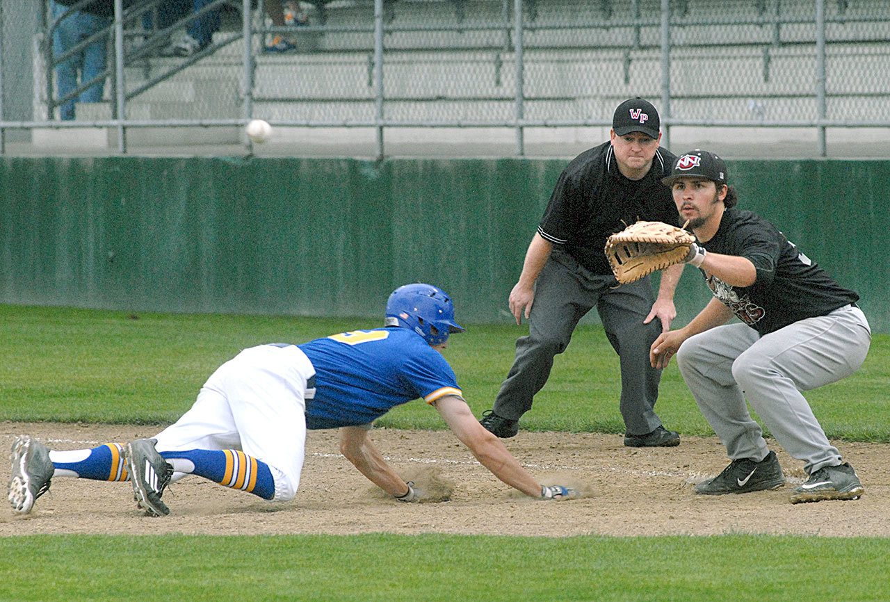 Keith Thorpe/Peninsula Daily News Taylor Adams of the Kitsap Bluejackets dives back to first as West Coast Guns first baseman Joe Siegel tries to catch him off base during their exhibition game on June 1 at Port Angeles Civic Field.