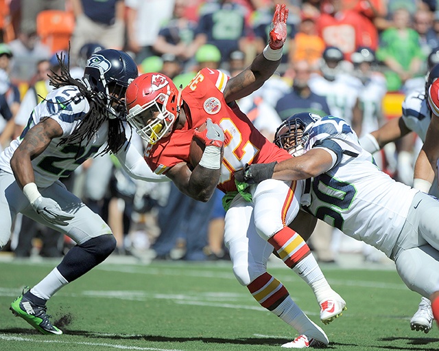 The Associated Press Kansas City Chiefs running back Spencer Ware (32) is tackled by Seattle’s K.J. Wright (50) and Richard Sherman (25) during the team’s first preseason game last week.