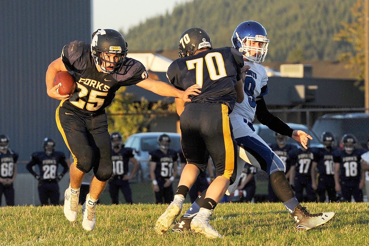 Lonnie Archibald/for Peninsula Daily News Forks running back Kenny Gale (25) heads up field aided by a sealing block from teammate Jack Dahlgren. Gale will get plenty of carries this fall, while Dahlgren will still be blocking, albeit from a new position, tight end.