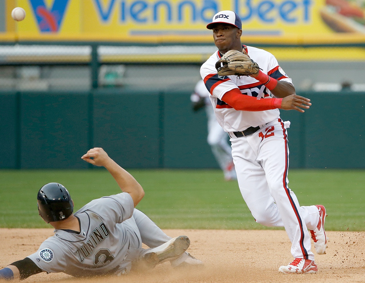 The Associated Press Chicago White Sox shortstop Tim Anderson, right, throws out Seattle Mariners’ Adam Lind at first base after forcing out Mike Zunino, left, at second base during Sunday’s game.