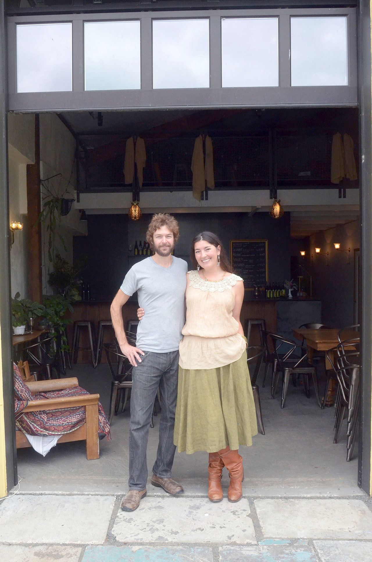Robert Horner and Piper Corbett, co-owners of Propolis Brewing, stand in the open doorway of their taproom in Port Townsend. Propolis Brewing was featured in Sunset magazine’s September issue as a great place to grab a drink this fall. (Cydney McFarland/Peninsula Daily News)