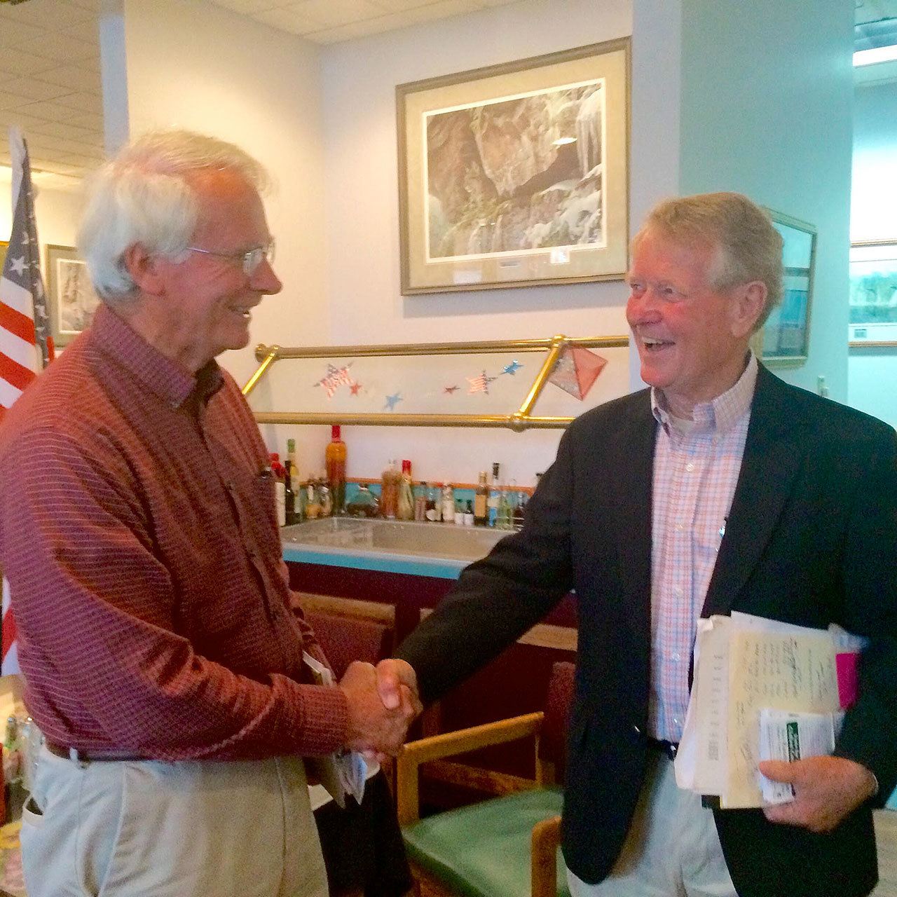 Clallam County commissioner candidates Ron Richards, left, and Randy Johnson share a light moment Tuesday morning after outlining their positions at an election forum. (Paul Gottlieb/Peninsula Daily News)
