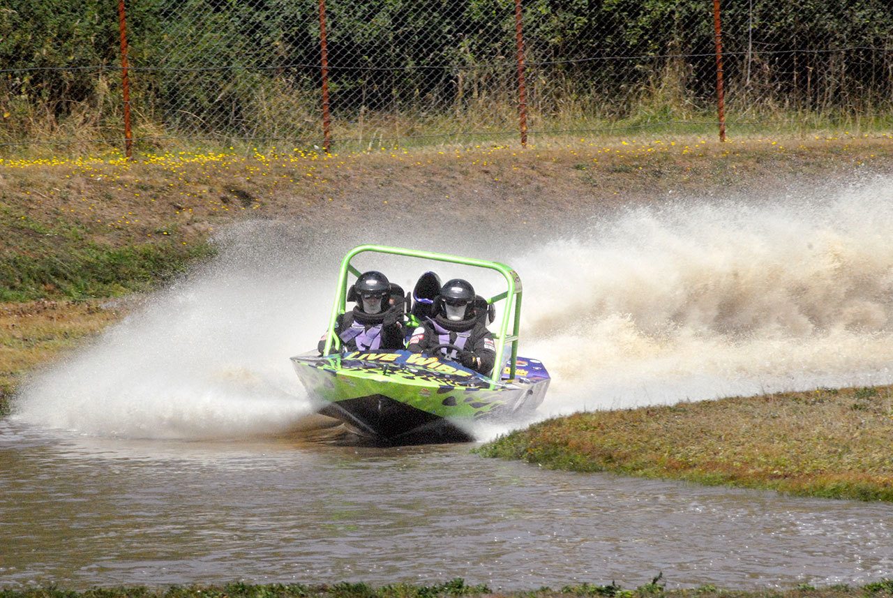 Keith Thorpe/Peninsula Daily News The Sequim-based Live Wire spint boat piloted by Paul Gahr, right, with Josh Gahr navigating makes its way around the course at the Extreme Sports Park in Port Angeles during racing in July.