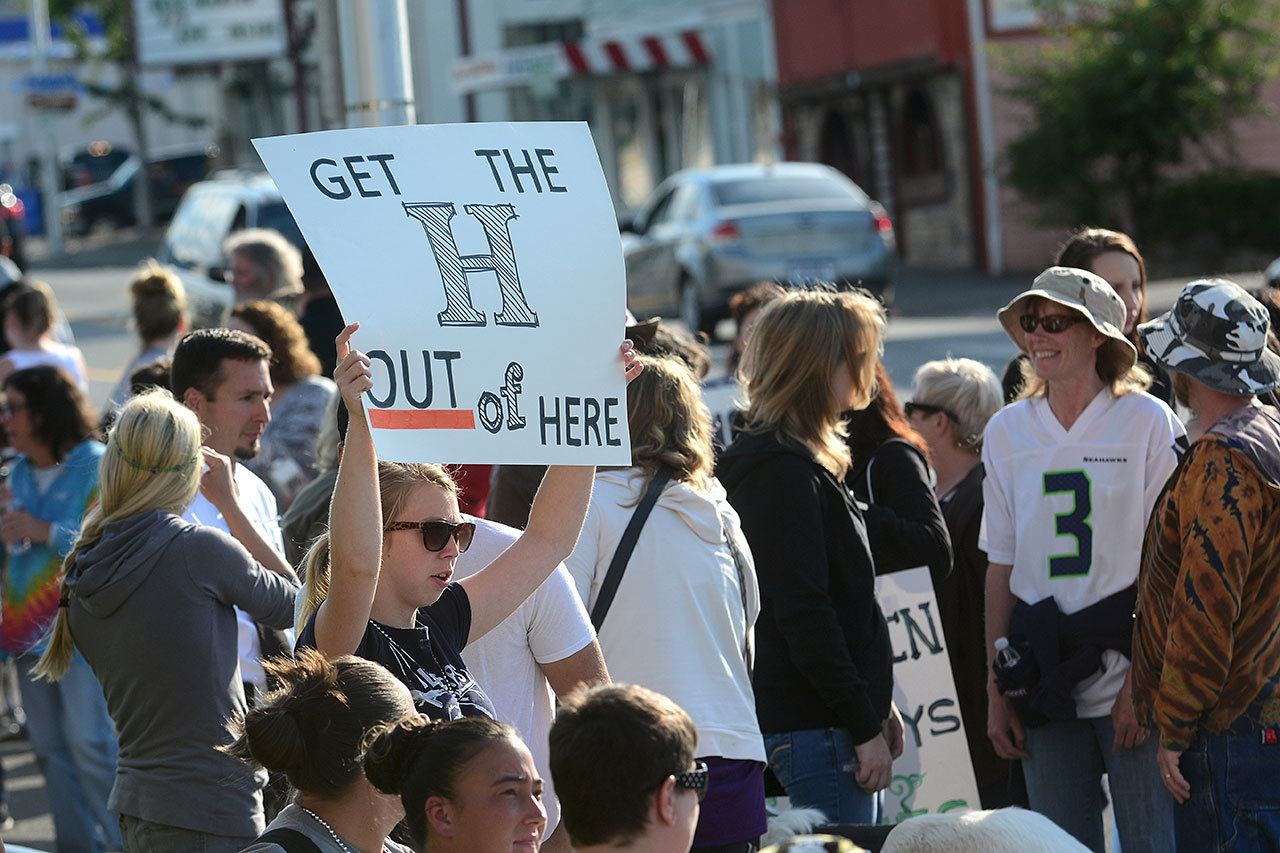 Shaina Holman of Port Angeles holds up a sign during the overdose awareness event. (Jesse Major/Peninsula Daily News)