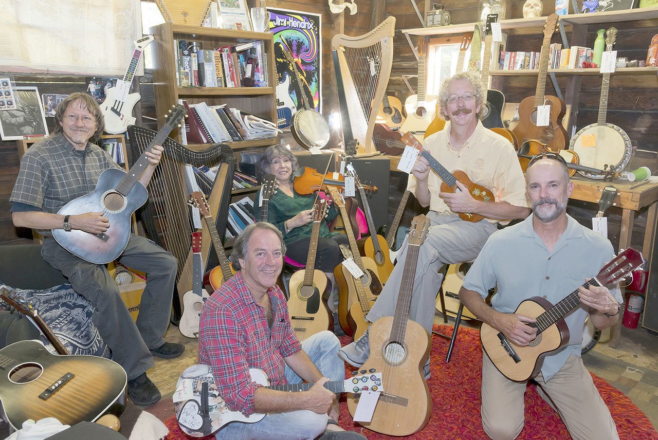 The Juan de Fuca Foundation of the Arts is seeking artists to paint old-stringed instruments to be auctioned off in January. From left are foundation board members Eric Neurath, Dan Maguire, Jennifer Bright, Clark Driese and Steve Gilchrist. (Juan de Fuca Foundation of the Arts)