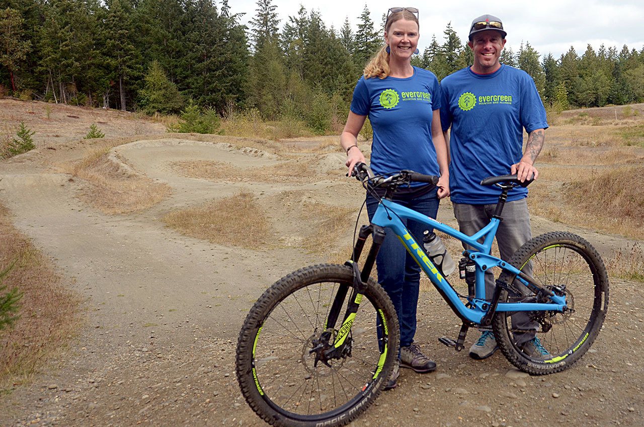 Jason Queen and Lily Hickenbottom stand in front of the bike track at H.J. Carroll Park in Chimacum. The two, along with Doug Ross and support from Jefferson County Parks and Recreation, hope to update the track to make it more usable for local riders. (Cydney McFarland/Peninsula Daily News)