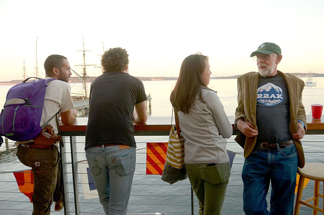 Race to Alaska fans and racers enjoy the view from the Northwest Marine Center in Port Townsend at the R2AK annual Blazer Party honoring winners from 2016 and announcing new rules for 2017. (Cydney McFarland/Peninsula Daily News)