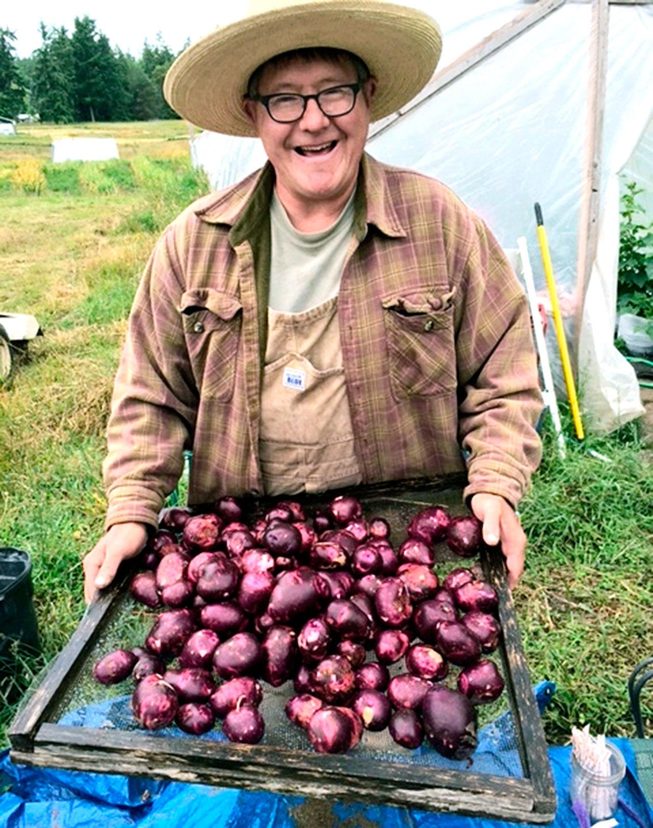 Max Lindert of Onatrue Farm in Port Townsend displays produce. (Amanda Millholland)