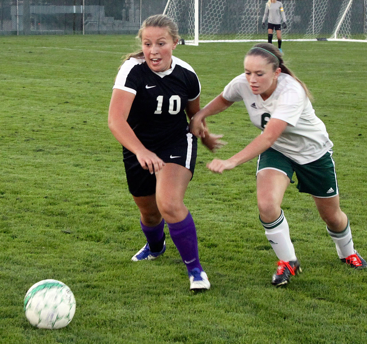David Logan/Peninsula Daily News Sequim’s Chloe Sparks, left, and Port Angeles’ Emily Boyd jostle for the ball during their rivalry match at Civic Field in Port Angeles. Sequim won 3-1 in a penalty kick shootout.