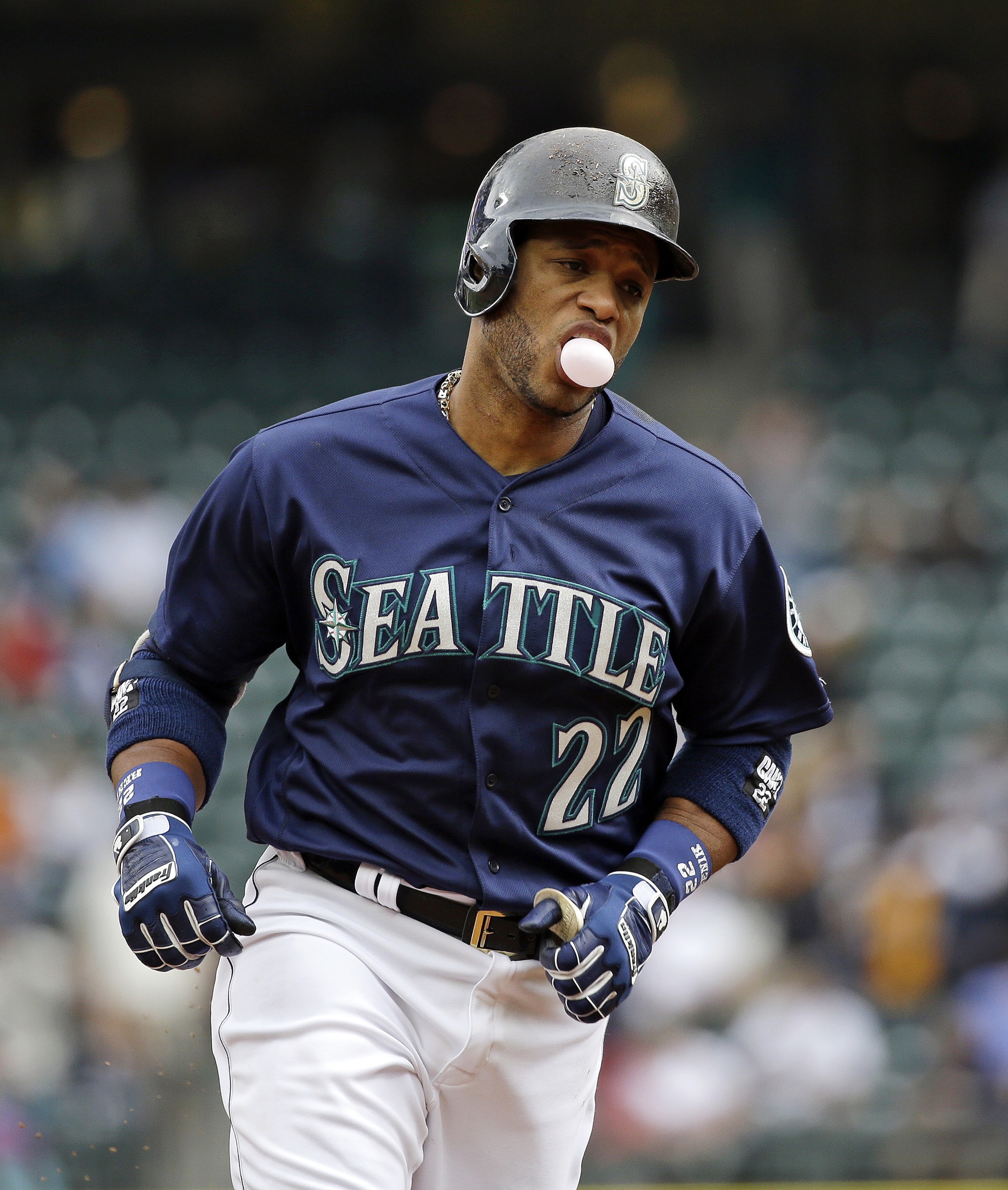 Seattle Mariners’ Robinson Cano blows a bubble as he rounds the bases on his two-run home run against the Texas Rangers during the first inning of a baseball game Monday, Sept. 5, 2016, in Seattle. (AP Photo/Elaine Thompson)