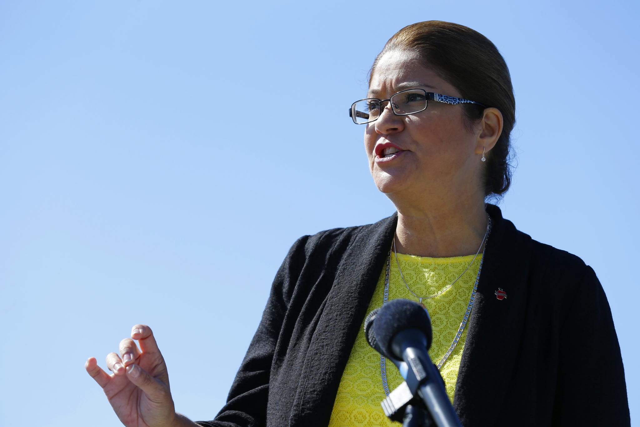Maia Bellon, director of the state Department of Ecology, speaks at a news conference Thursday overlooking Elliott Bay in Seattle. Washington state environmental regulators finalized a new rule Thursday to limit greenhouse gas emissions from large polluters. (Ted S. Warren/The Associated Press)