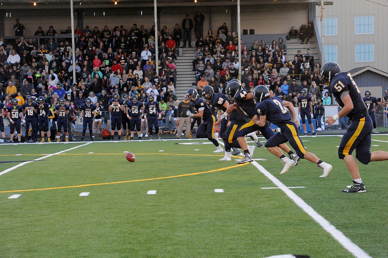 Lonnie Archibald/for Peninsula Daily News Forks tries an onside kick during last Friday’s 42-26 win over Vashon. The Spartans have switched sidelines at Spartan Stadium this season and are now back on the traditional home side of the field.
