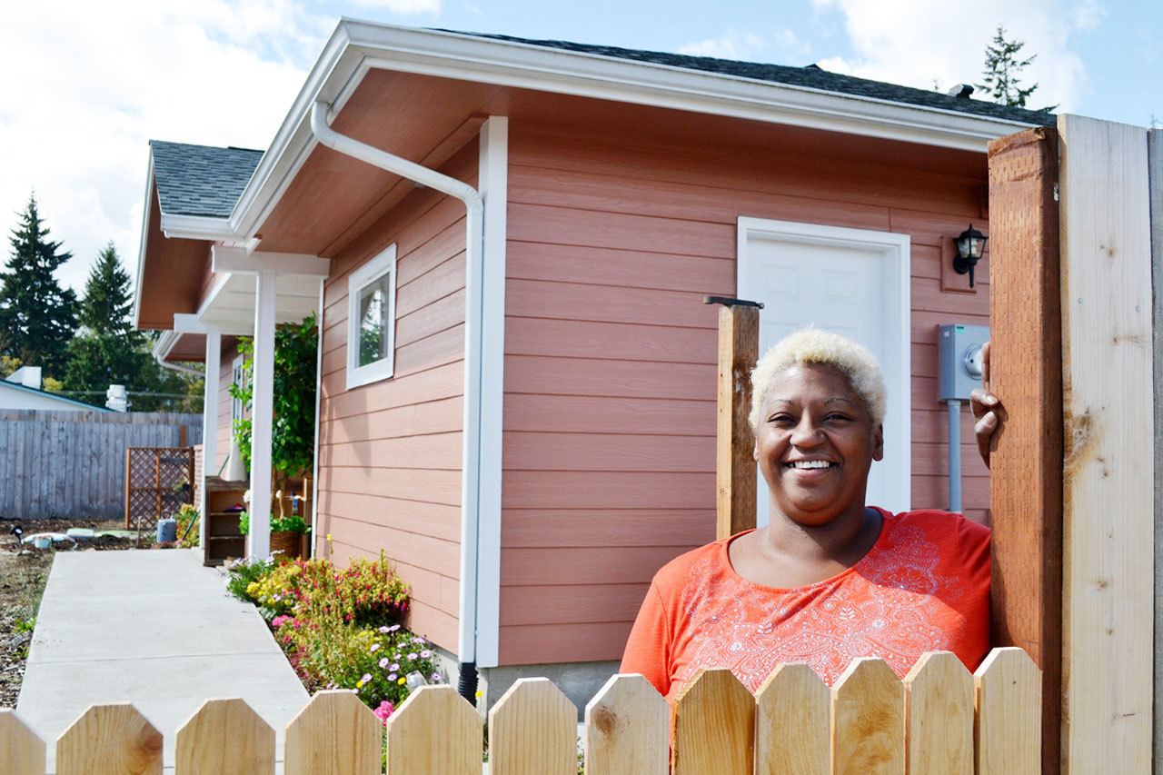 Eula Cook stands outside her new home in Port Angeles’ Maloney Heights Subdivision. After almost nine years in Sequim, she received assistance through Habitat for Humanity of Clallam County to purchase her own home. (Matthew Nash/Olympic Peninsula News Group)