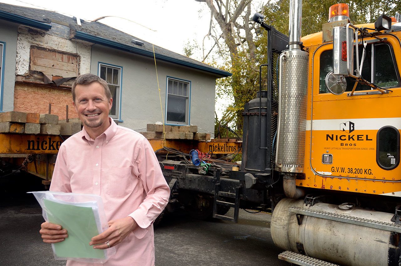 Joe Johnson of Johnson Family Properties NW stands in front of one of the homes floated in from Victoria on a barge Tuesday night. (Cydney McFarland/Peninsula Daily News)