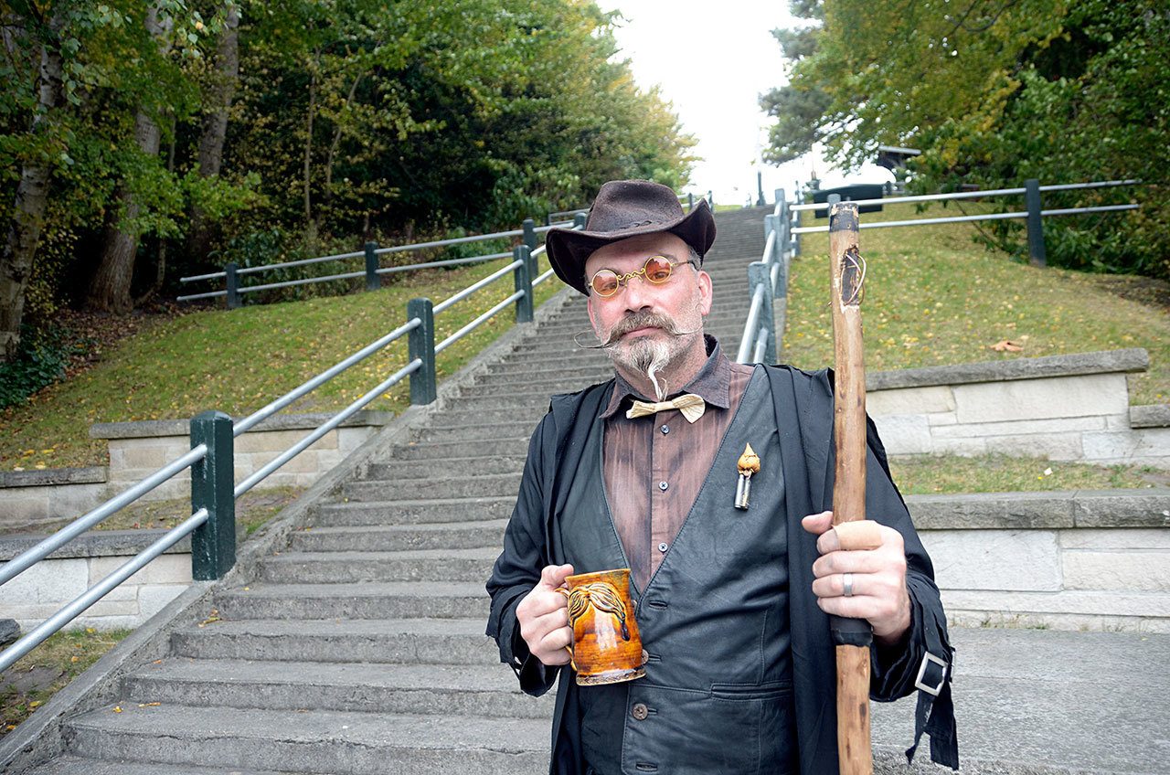 Geoff ‘Grymm’ Gardner of Twisted History Tours stands in front of the stairs in Port Townsend thought by some to be haunted by the ghost of a woman shot and killed there in the 1890s. It’s one of many haunted locations featured on the Twisted History downtown tour. (Cydney McFarland/Peninsula Daily News)