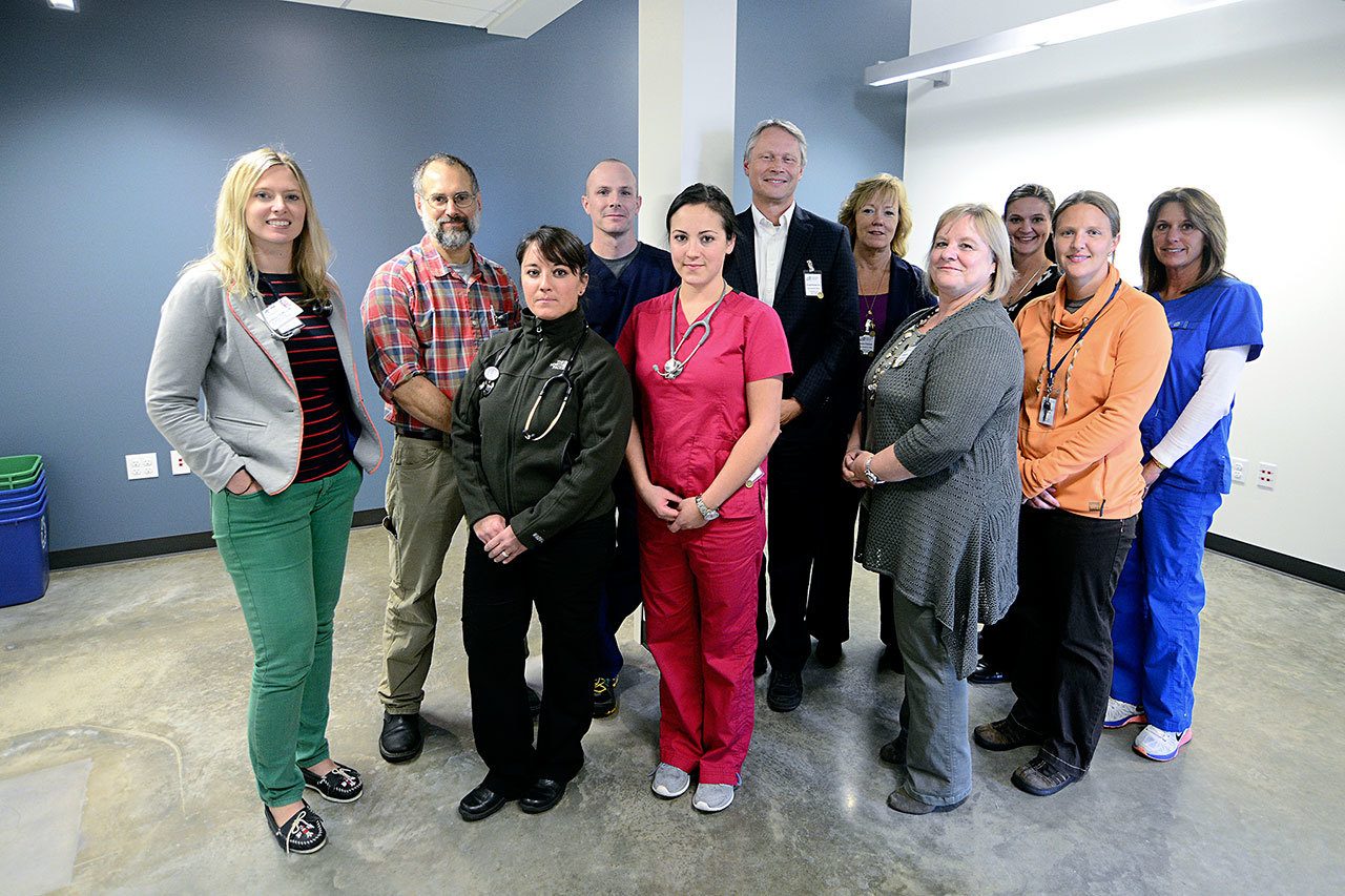 In back row from left are Dr. Jessica Colwell, Dr. Rob Eptsein, Isaac Ballou, CEO Michael Maxwell, COO Karen Paulsen, Tammy Reid and Heidi Wilson; in front row from left are Courtney Kacouros, Jenalee Attwood, Margie Warren and Kate Ballou. (Jesse Major/Peninsula Daily News)