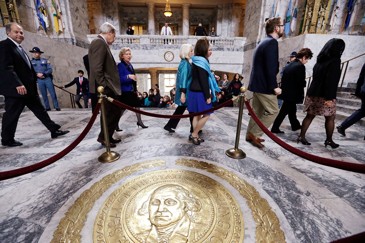 Senators walk through the rotunda and toward the House chamber to a joint session of the state Legislature in Olympia on March 18, 2015. (Elaine Thompson/The Associated Press)