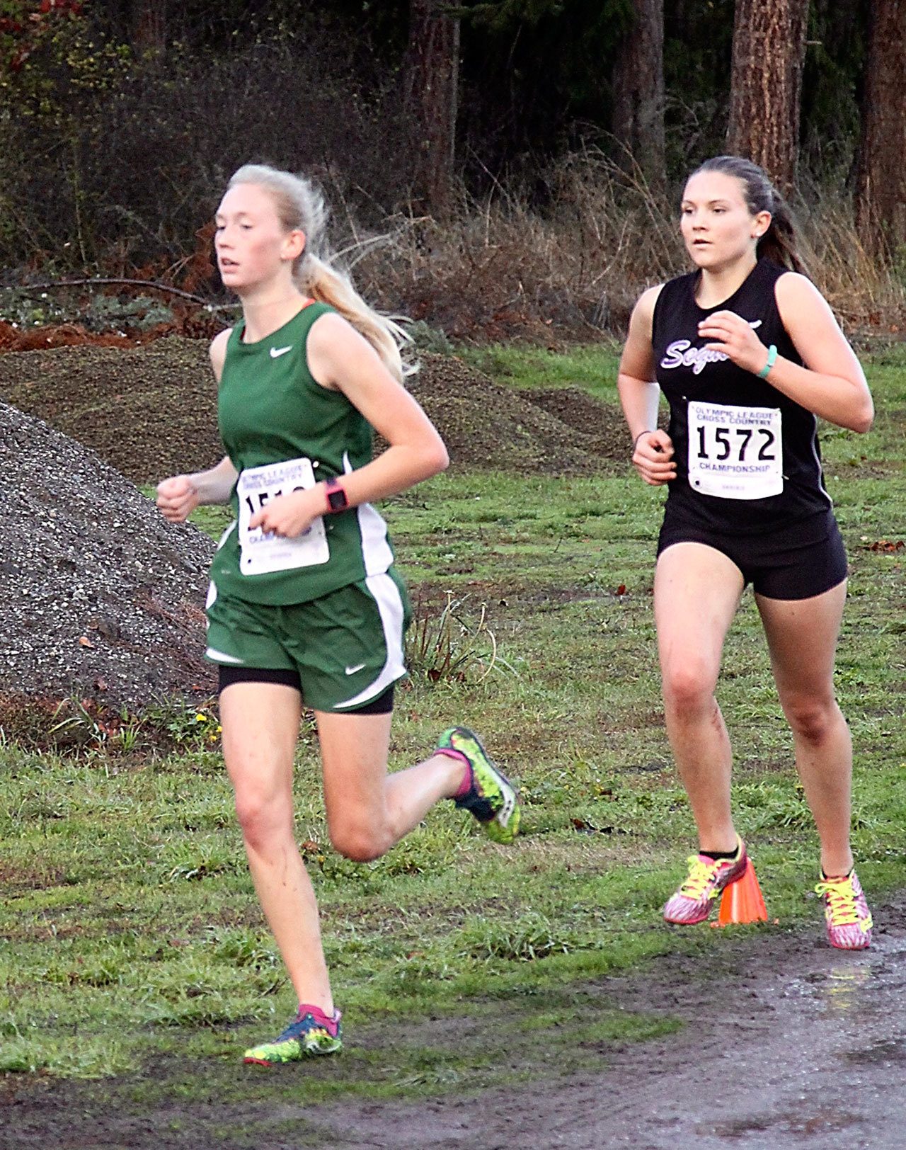 Dave Logan/For Peninsula Daily News Port Angeles’ Gracie Long, left, won the Olympic League girls cross country title while Sequim’s Morgan Bingham finished second. The Roughriders claimed the team title as well.