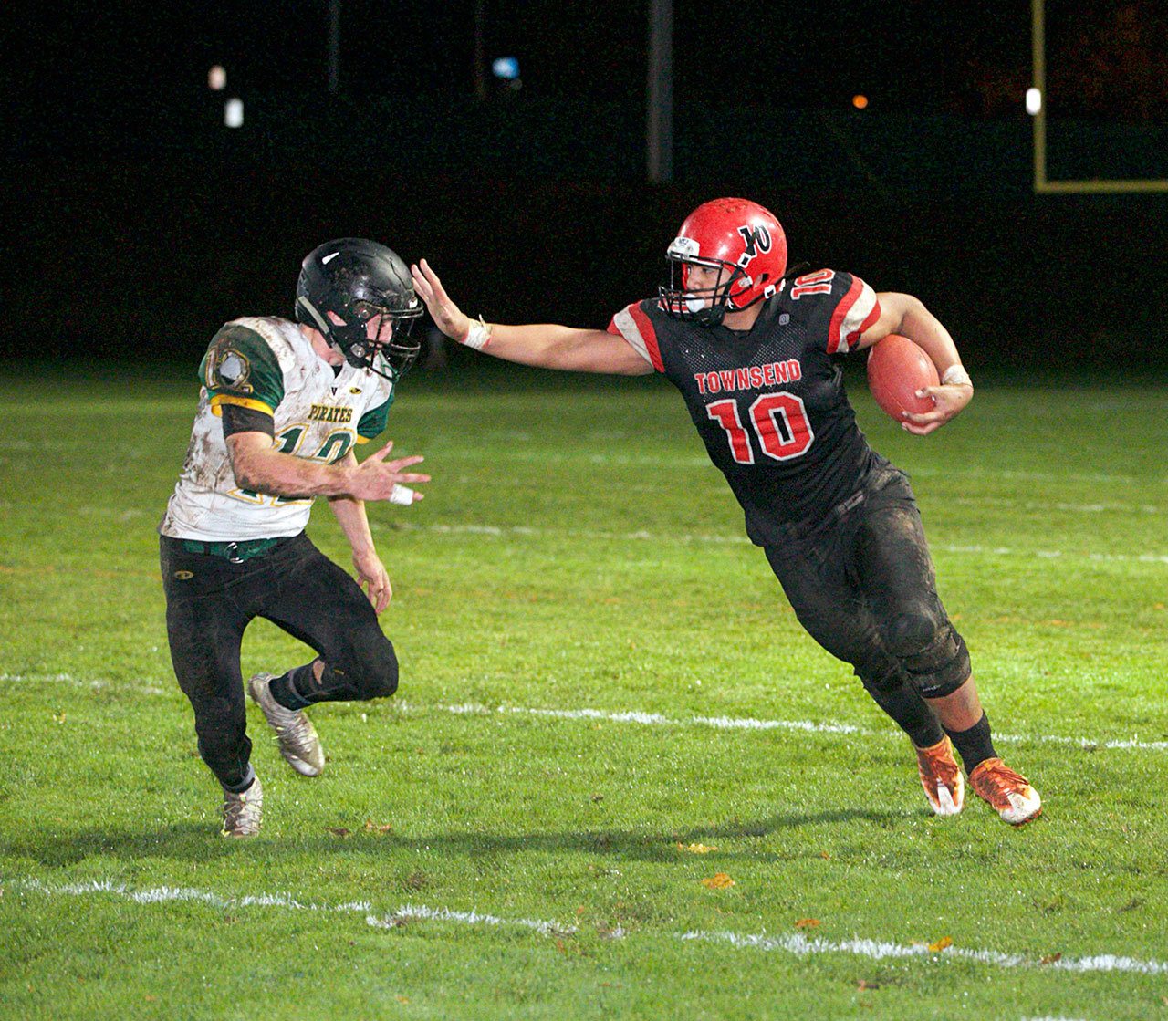 Steve Mullensky/for Peninsula Daily News                                Port Townsend’s Detrius Kelsall, 10, stiff-arms Vashon’s Connor Hoisington, during a Friday game played in Memorial Field in Port Townsend.
