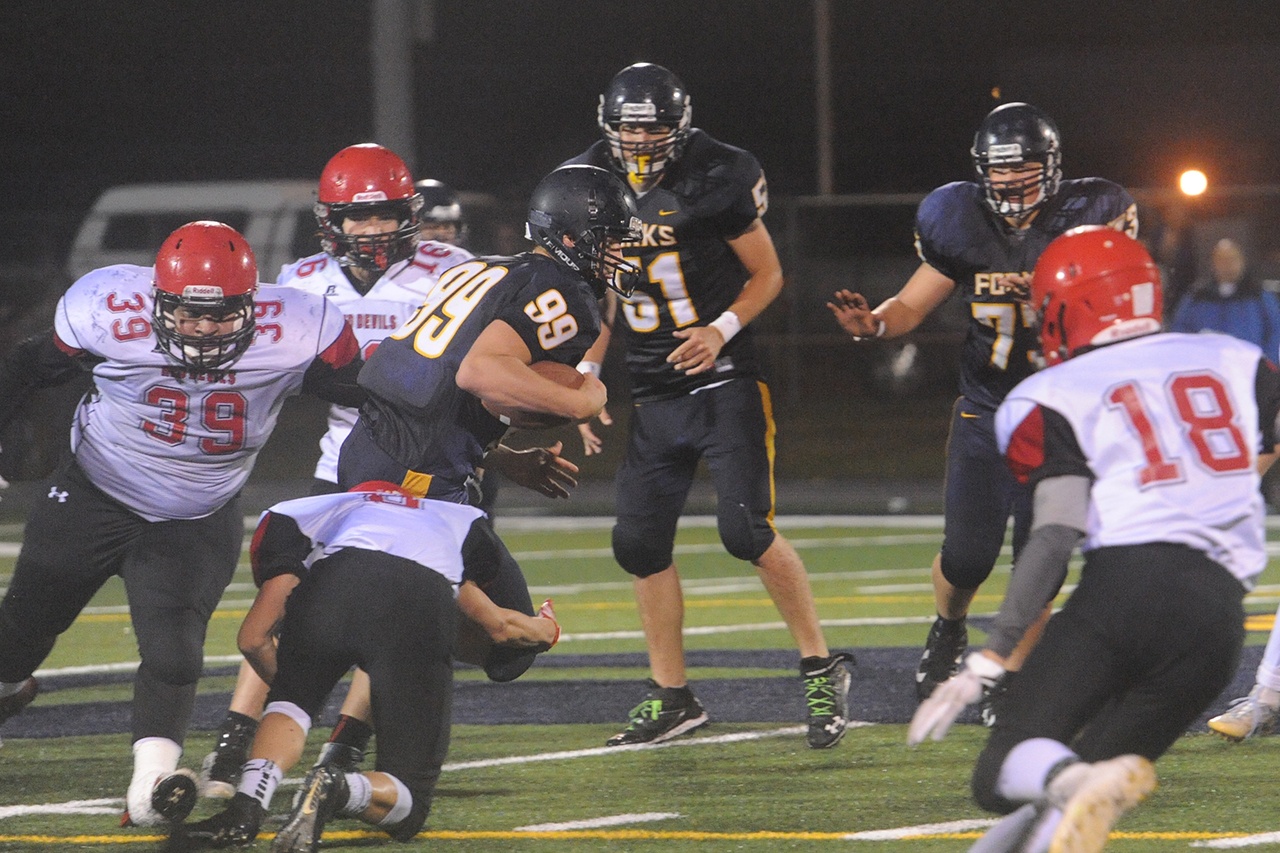 Lonnie Archibald/for Peninsula Daily News                                Forks’ Jack Dahlgren (99) runs through Neah Bay defenders Curtis LaChester (39) Cole Svec (16) and Logan Halttunen (8) and Josey Tyree (18) on his way to a big gain earlier this season. The Spartans host Hoquiam tonight with a shot at the Evergreen League’s second seed to the district playoffs.