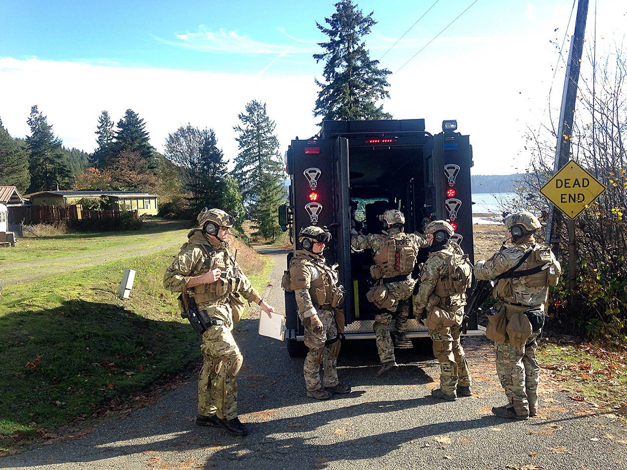 A SWAT team from Tacoma prepares for a standoff on Robinson Road near U.S. Highway 101 in Brinnon. (Cydney McFarland/Peninsula Daily News)