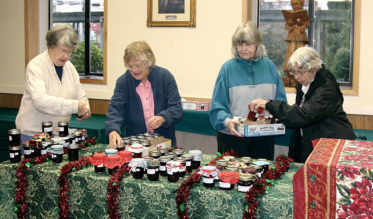 “Jammers” Sandra Crook, Sudie Mason, Katt Osborne and Betty Nicholson, from left, start to set out the more than 400 handmade half-pint jars of jams and jellies women of First United Methodist Church in Port Angeles have made this year. One of their specialties will be a preserve called “gourmet mustard.”