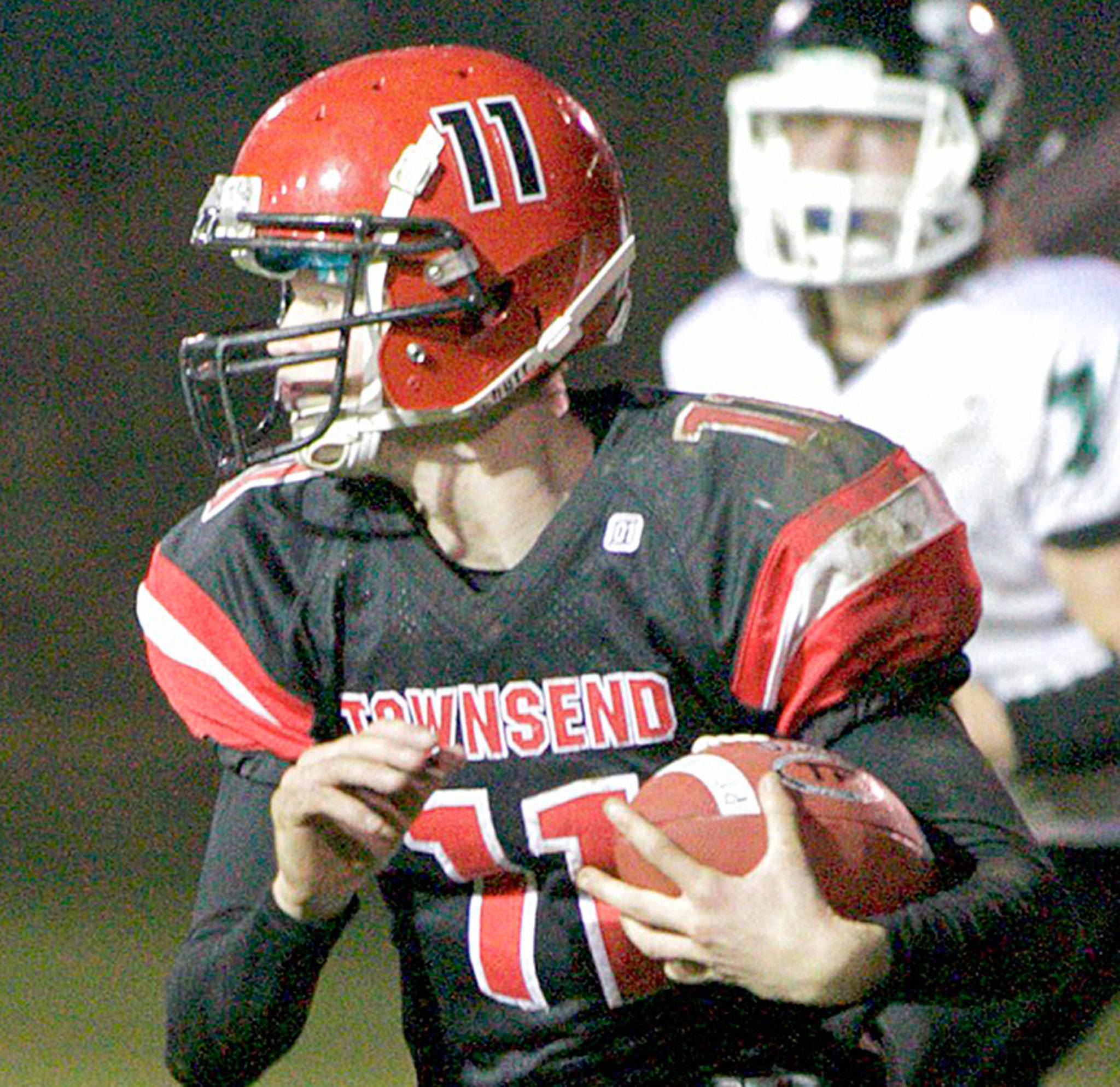 Steve Mullensky/for Peninsula Daily News Redhawk Berkley Hill picks up a block and rushes for a first down in a Monday night game in Port Townsend against the Klqhowya Eagles.