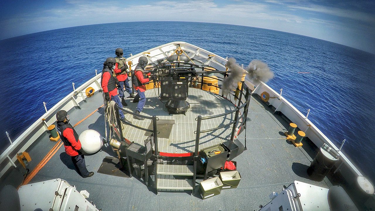 A crew member aboard the Coast Guard cutter Active, a 210-foot medium-endurance cutter homeported in Port Angeles, fires a 25mm gun during underway training Sept. 10. (U.S. Coast Guard)