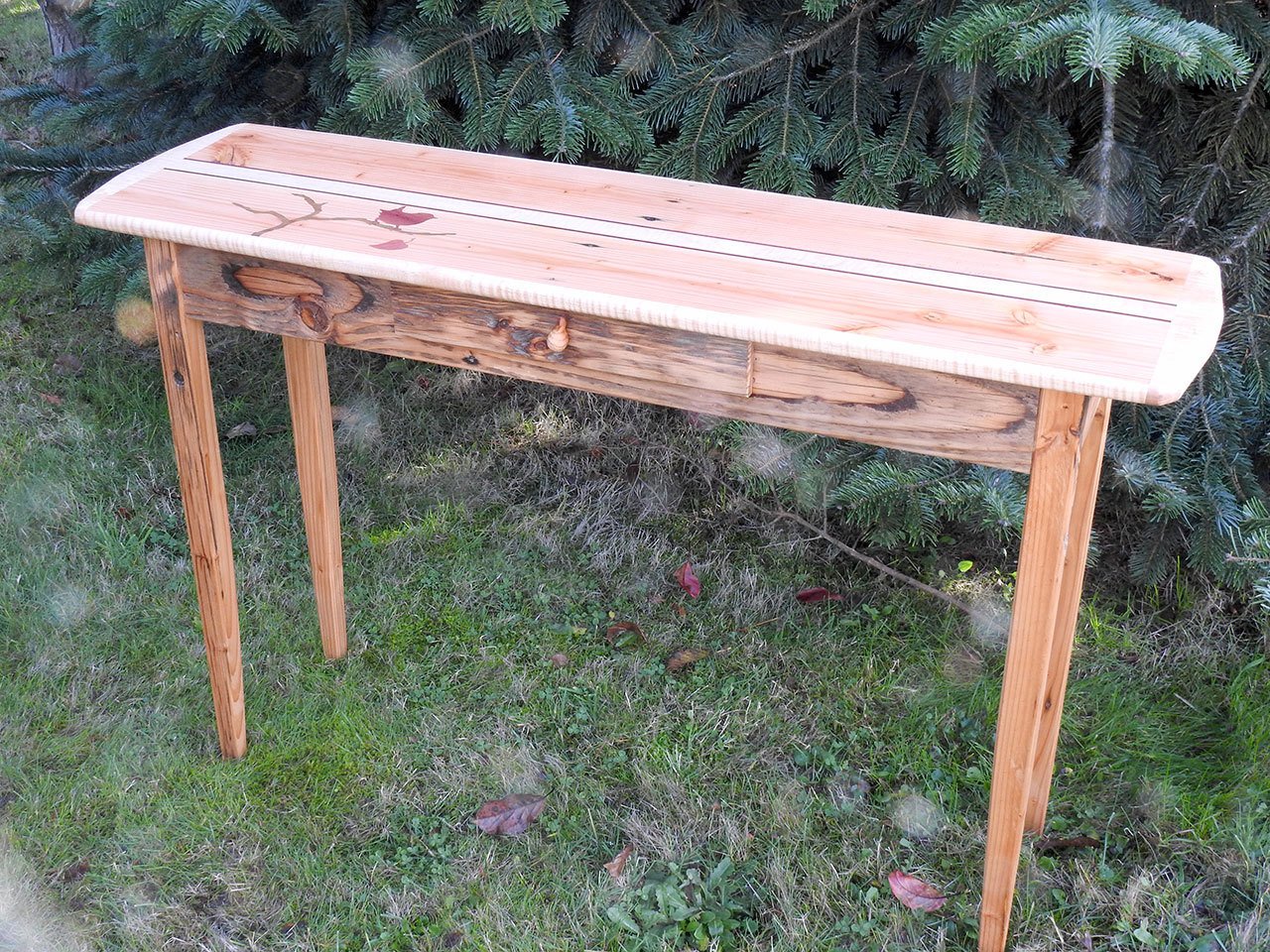 Using boards salvaged from the old Railroad Bridge decking, craftsman Tom Butler created a one-of-a kind, 45-inch-long table.