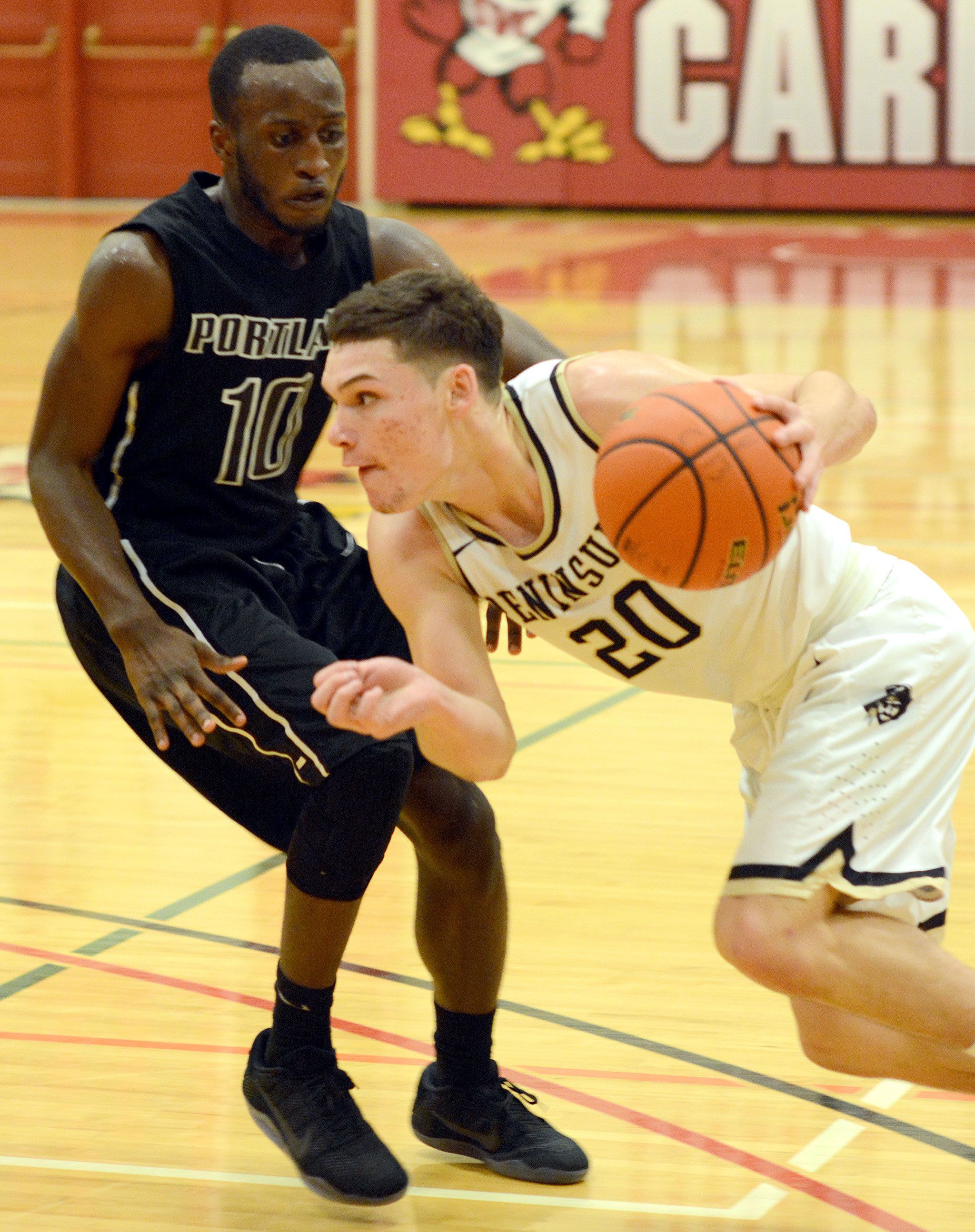 Peninsula College photo                                Peninsula College’s Cole Rabedeaux, North Kitsap grad and 2016 Olympic League MVP, drives on Portland’s Dario Papa-Vicente during the Pirates’ game Saturday at the Skagit Valley Turkey Tournament in Mount Vernon.