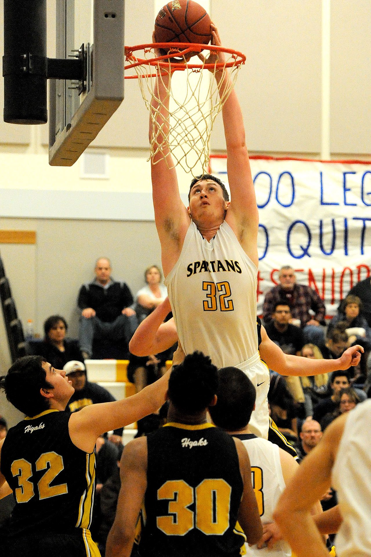 Lonnie Archibald/for Peninsula Daily News Forks’ Marky Adams (32) dunks over North Beach defenders in the Spartans’ 66-58 non-league win Tuesday.