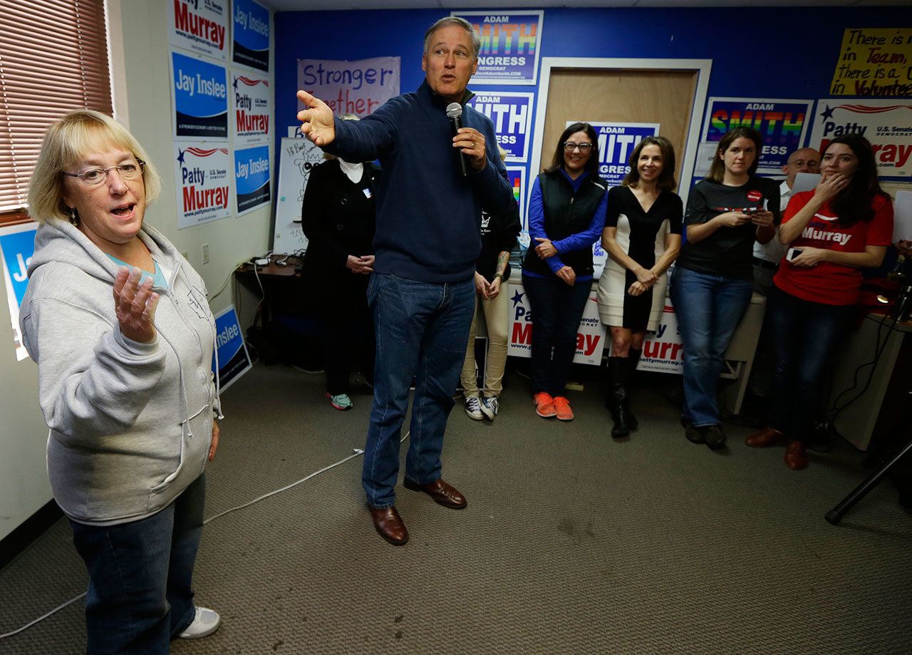 Gov. Jay Inslee, second from left, talks about Sen. Patty Murray, D-Wash., left, on Friday as they speak to campaign volunteers and other supporters during a get-out-the-vote rally at a campaign office in Seattle. (Ted S. Warren/The Associated Press)