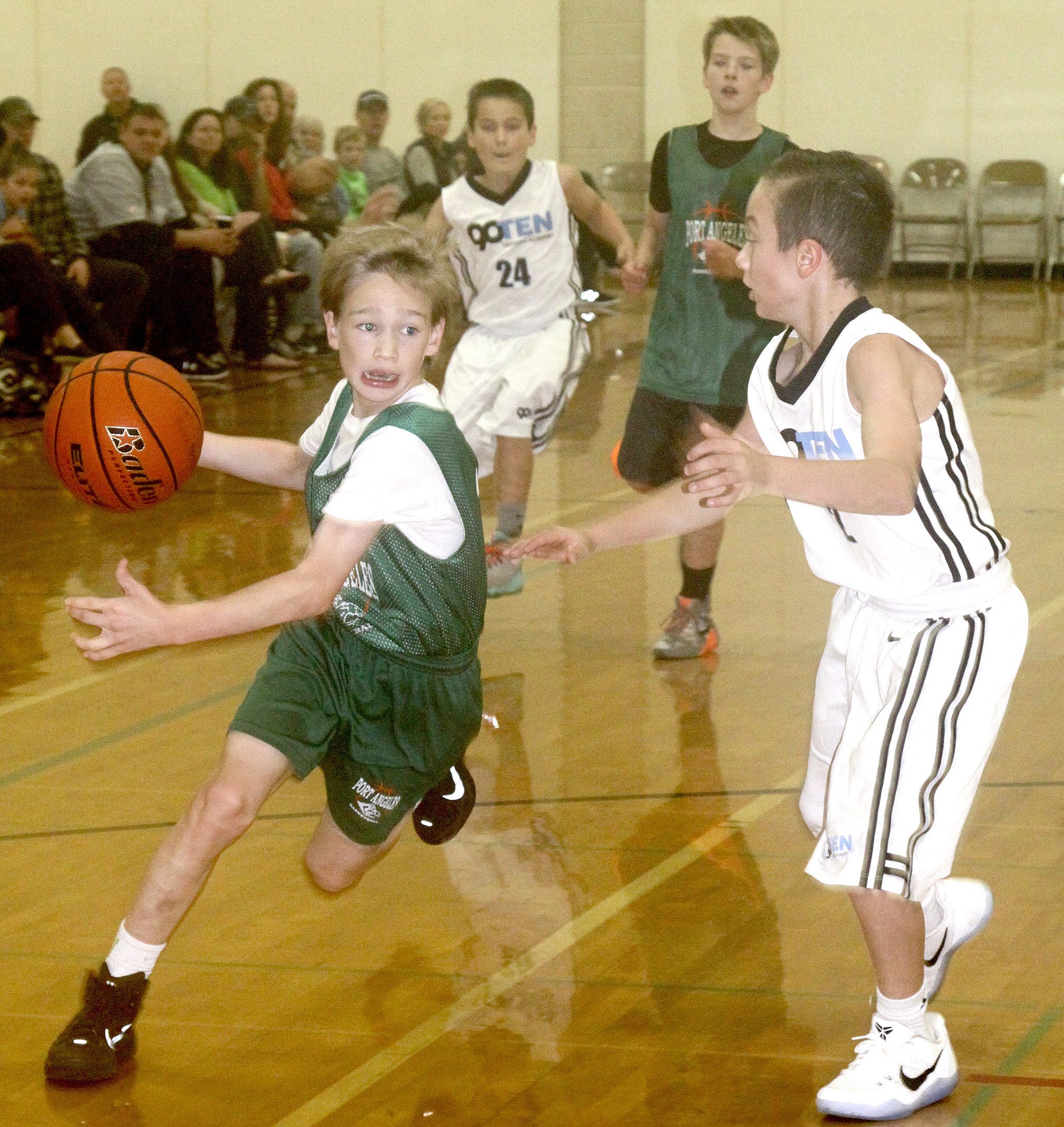 David Logan/For the Peninsula Daily News                                The two day Tip-Off Basketball Tourney was held this weekend at the PAHS gym and Roosevelt gym. Twenty-six girls and boys’ teams in grades 6th through 8th participated with teams coming from as far as Marysville and Tumwater. Port Angeles Park and Rec sponsored the tournament. Josiah Long of the 6th-grade Port Angeles team drives around a Tumwater opponent. The Port Angeles team went on to win the game 28-19 on Sunday morning.