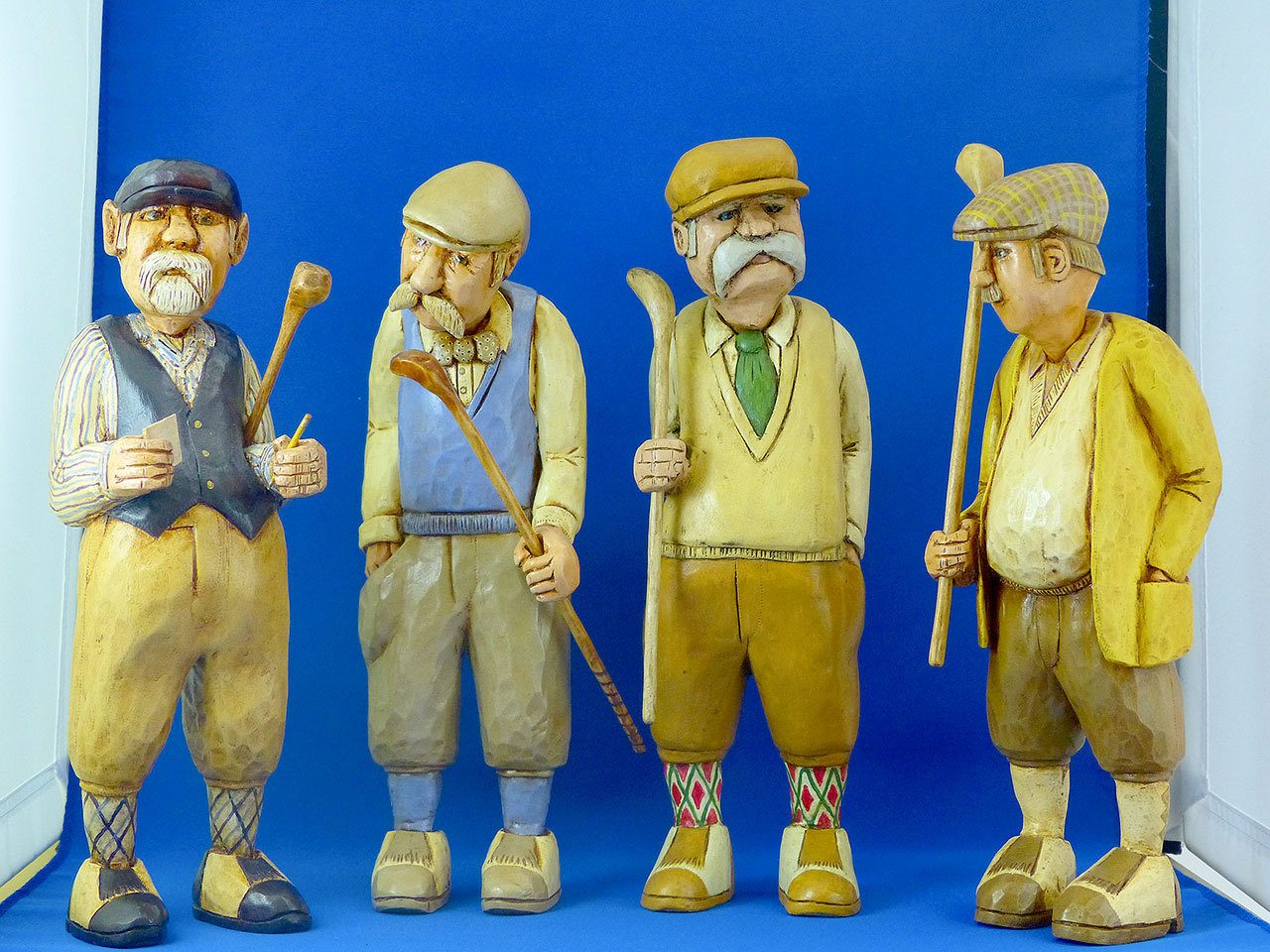 These wood carvings of English golfers by Pat Donlin will be on display Saturday during the 11th annual Wooden Art Show in Sequim. (Pacific Northwest Wood Artisans)