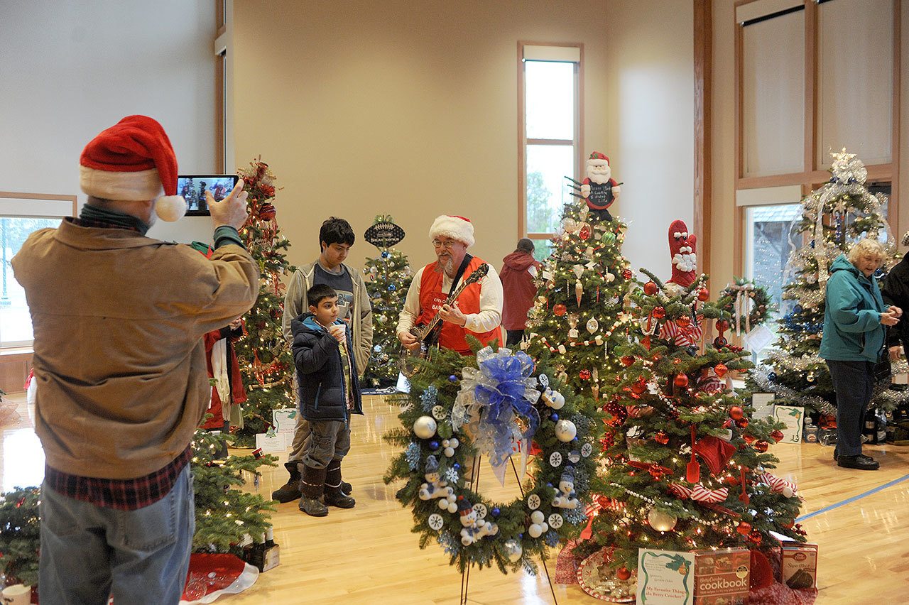 Mark Johnson provided entertainment during last year’s Forks Festival of Trees at the Rainforest Arts Center. (Lonnie Archibald/for Peninsula Daily News)