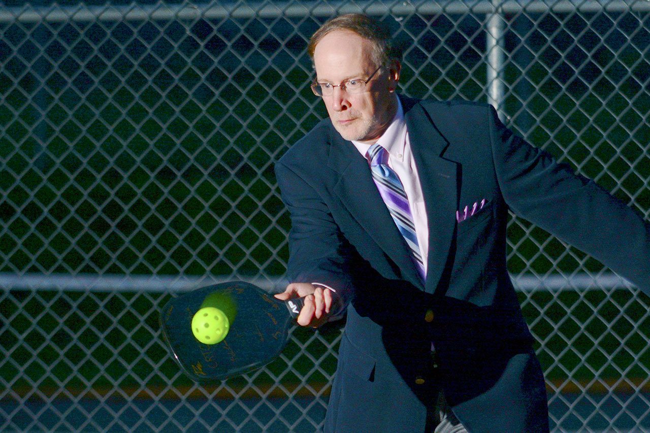 Dave Walter, chief operations officer at the Composite Recycling Technology Center in Port Angeles, demonstrates the CRTC’s first product, a recycled aerospace-quality carbon fiber pickleball paddle. The paddle is the first product in the world made of recycled aerospace carbon fiber. (Jesse Major/Peninsula Daily News)