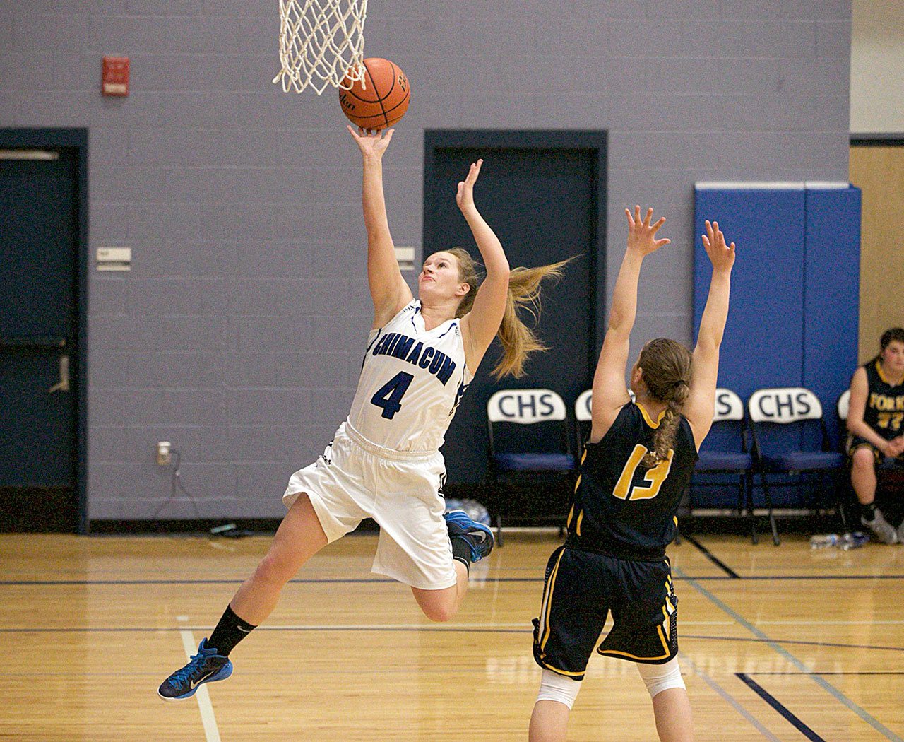 Steve Mullensky/for Peninsula Daily News Chimacum’s Mechelle Nisbet goes up for a basket against Forks defender Ryan Peters, during a game in Chimacum on Friday.