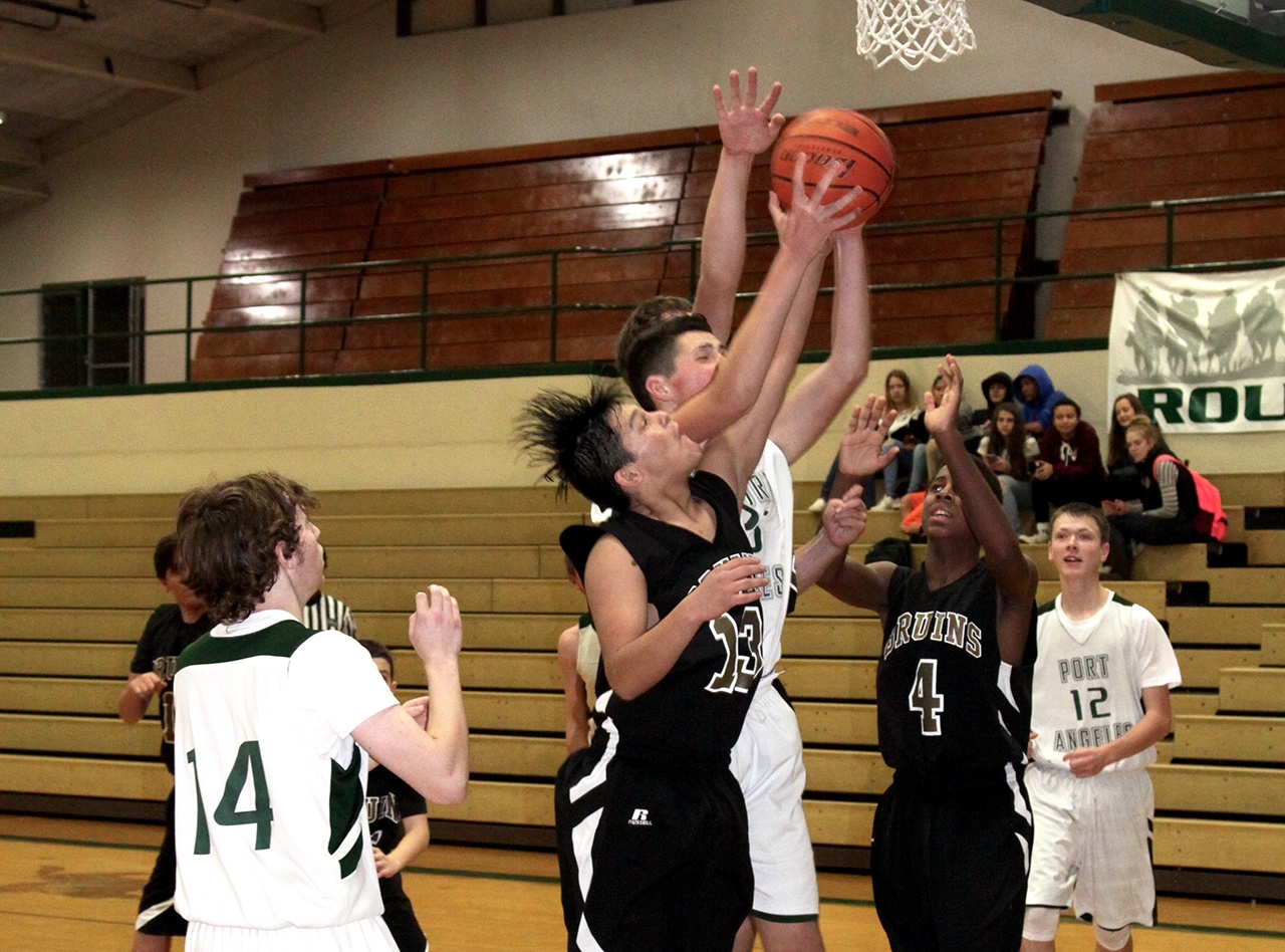 Dave Logan/for Peninsula Daily News                                Clallam Bay’s Ramon Tinoco (13) and Port Angeles C Squad’s Henry Irwin (with ball) compete for a rebound Also visible from left, are Port Angeles’ Tanner Lunt, Clallam Bay’s Jamari Signor and Port Angeles’ Jadon Seibel.