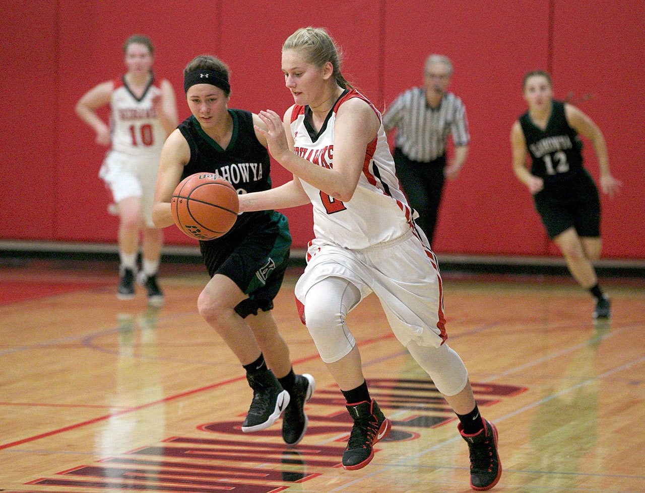 Steve Mullensky/for Peninsula Daily News Port Townsend’s Jaz Apker-Montoya, 2, races past Klahowya’s AmberBumbalough during the Redhawks’ 54-50 home victory.
