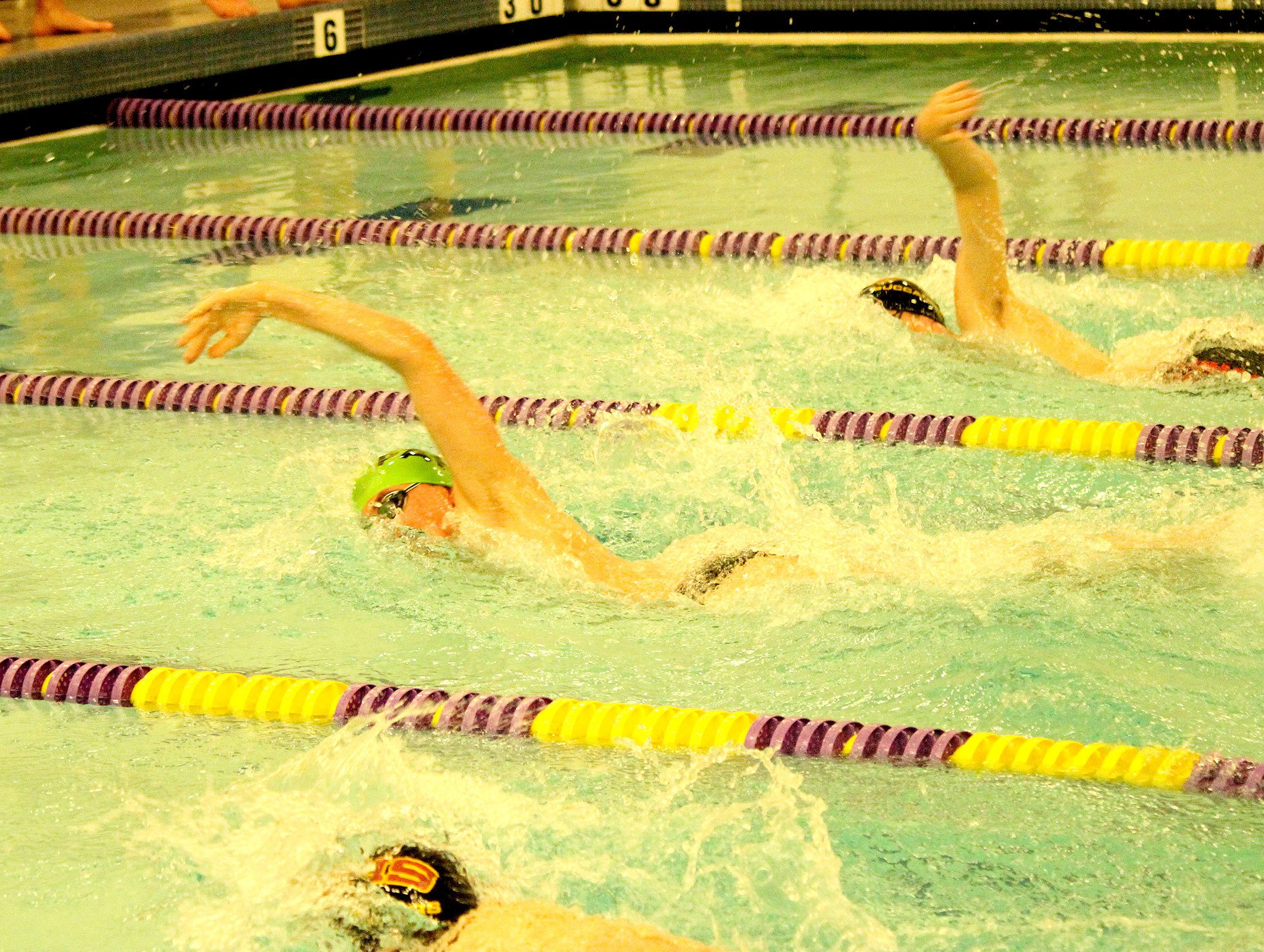 Patty Reifenstahl                                Port Angeles’ Tristin Butler (center) qualifies for state with a time of 5:03.81 in the 500 freestyle in a meet against Kingston.                                Patty Reifenstahl Port Angeles’ Tristin Butler (center) qualifies for state with a time of 5:03.81 in the 500 freestyle in a meet against Kingston.
