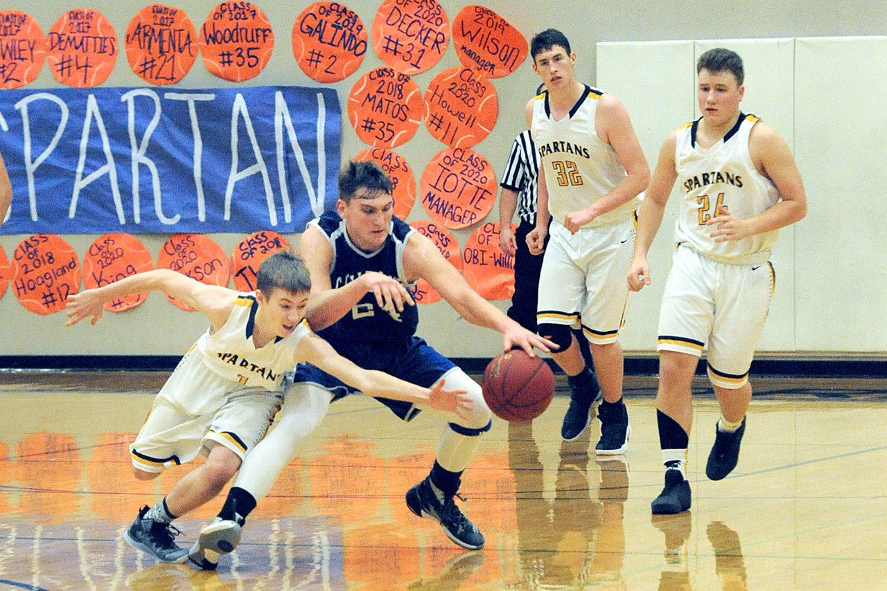 Lonnie Archibald/for Peninsula Daily News Forks’ Seth Johnson (1) goes for the steal against Chimacum’s Devyn Winkley (24) while the Spartans’ Marky Adams (32) and Cort Prose (24) look on.