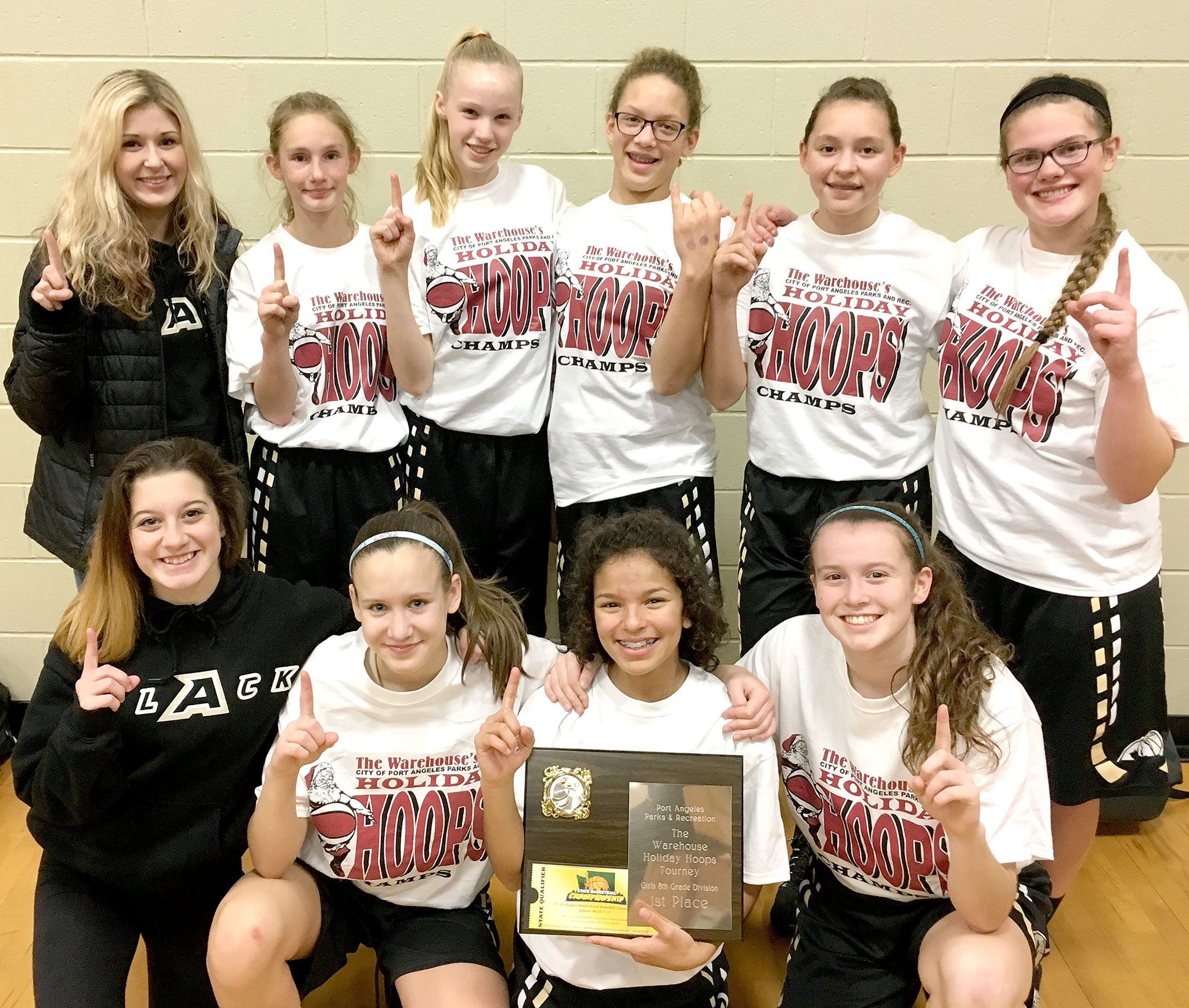 Courtesy photo The Olympic Avalanche Black eighth-grade girls’ team celebrate winning the Warehouse Holiday Hoops title. From left, rear are assistant coach Krissy Marvelle, Emilia Long, Maggie Ruddell, Madison Cooke, Jada Cargo and Myra Walker. From left, bottom, are manager Khloe Stanard, Hannah Reetz, Camille Stensgard and Jaida Wood.
