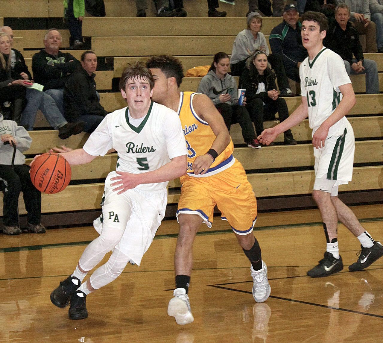 Dave Logan/for the Peninsula Daily News Port Angeles’ Noah McGoff, left, drives to the hoop while Bremerton’s Diontae Madison goes for the steal during the Roughriders’ 53-44 win over the Knights.