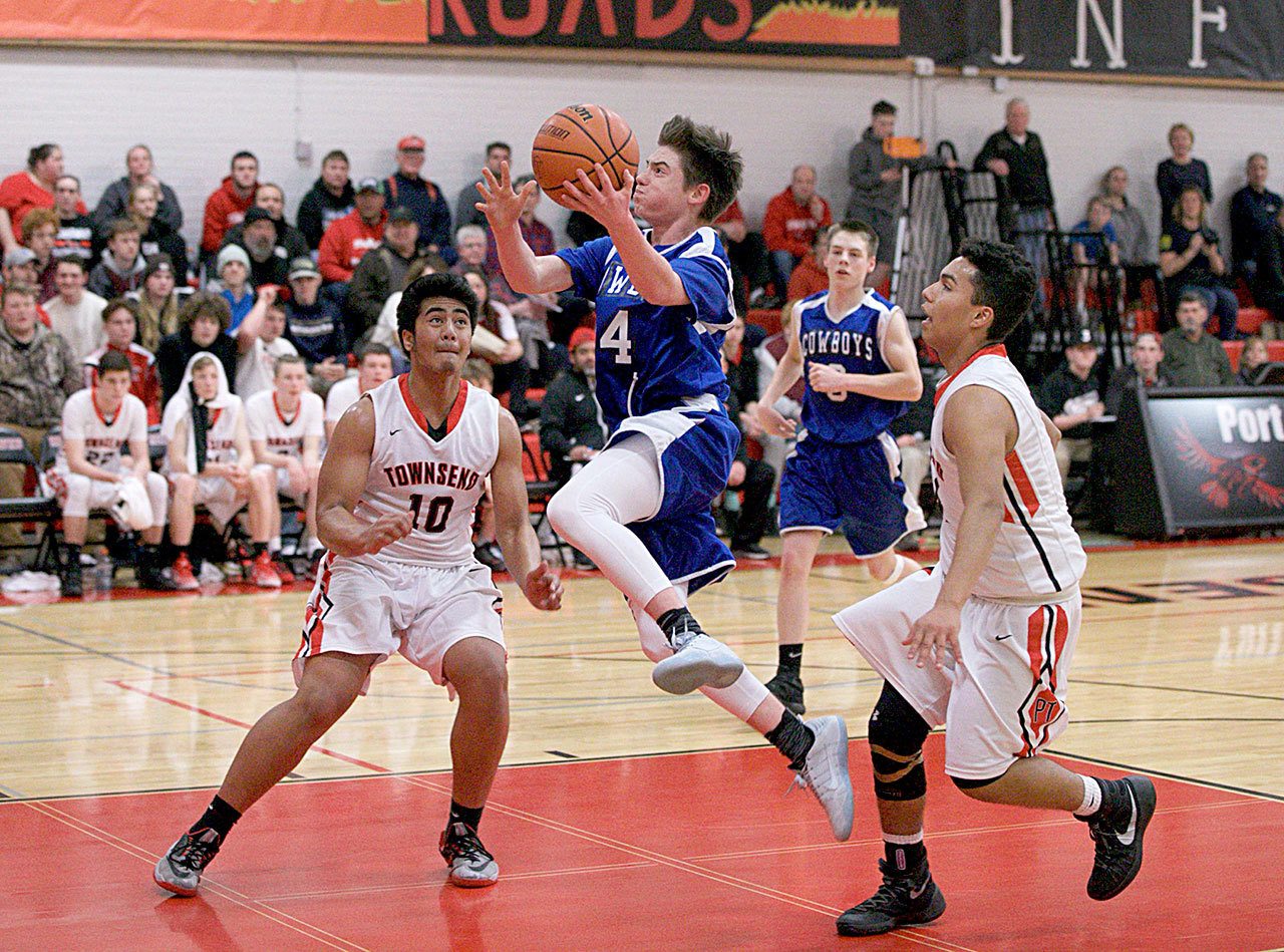 Steve Mullensky/for Peninsula Daily News Chimacum’s Issac Purser goes up for a score as Port Townsend Redhawks Detrius Kelsall, 10, and Jacob Boucher watch during a game on Tuesday in Port Townsend.